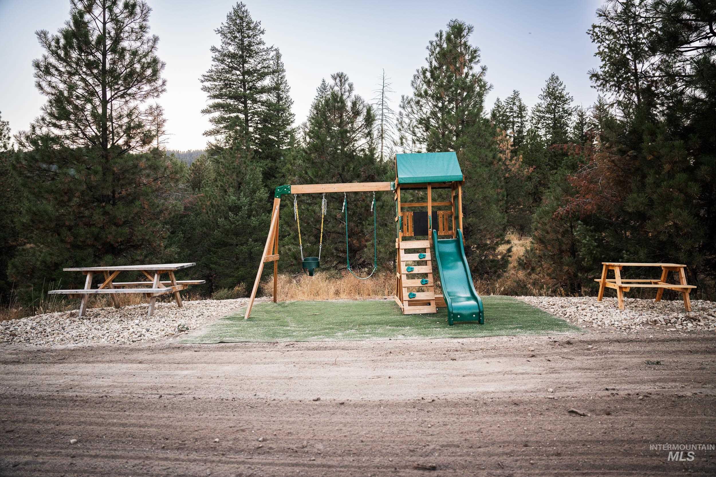 Community playground featuring a view of trees
