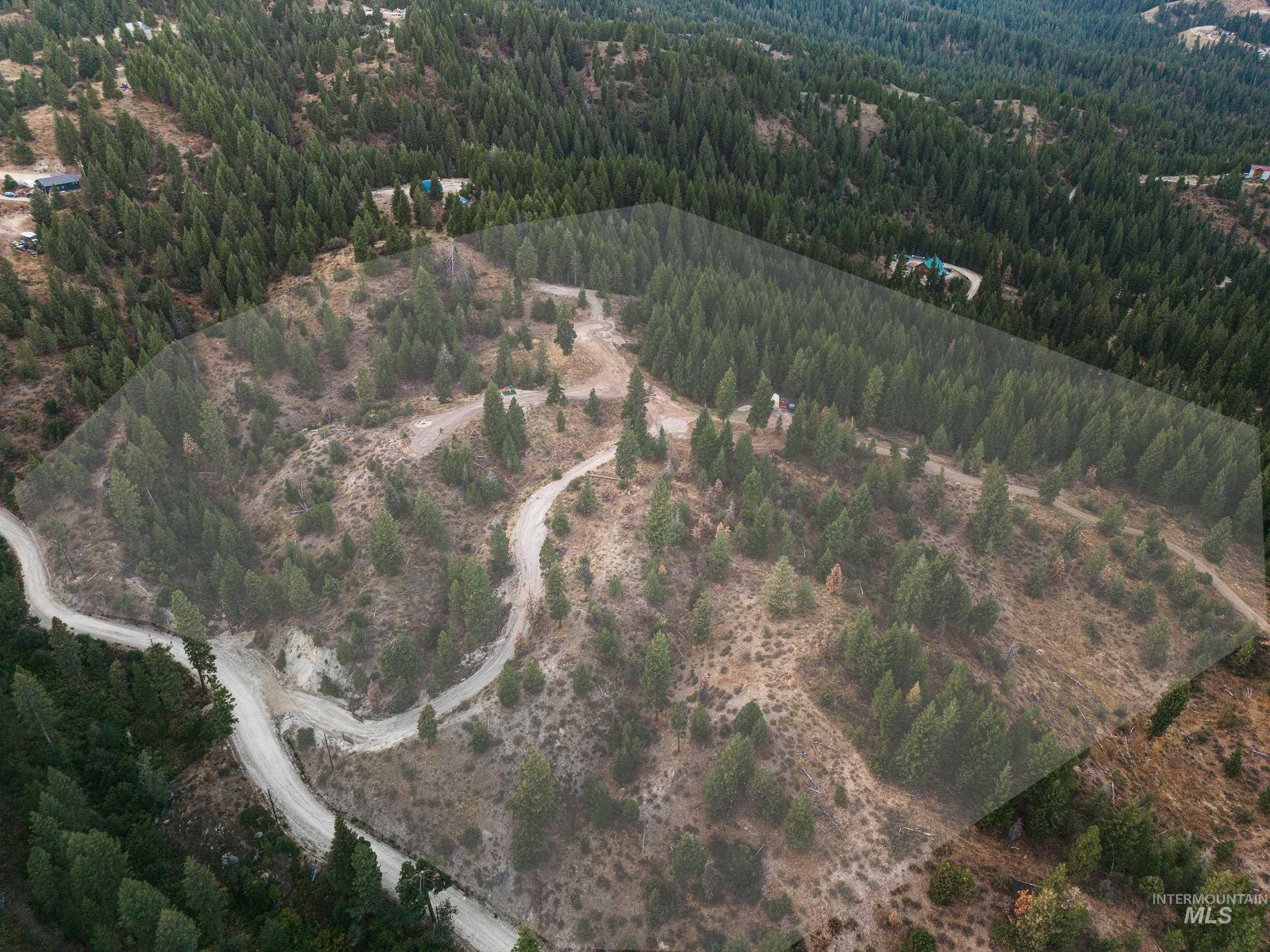 Aerial overview of property's location featuring a heavily wooded area