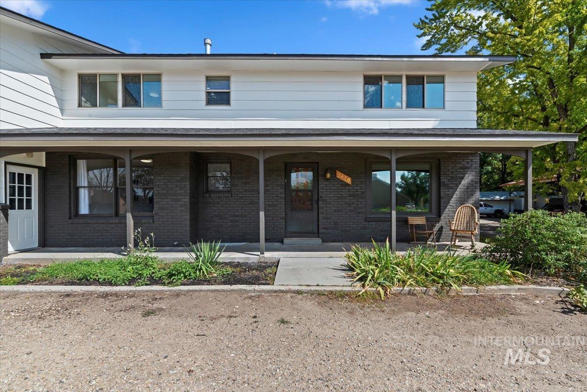 View of front facade with brick siding and covered porch
