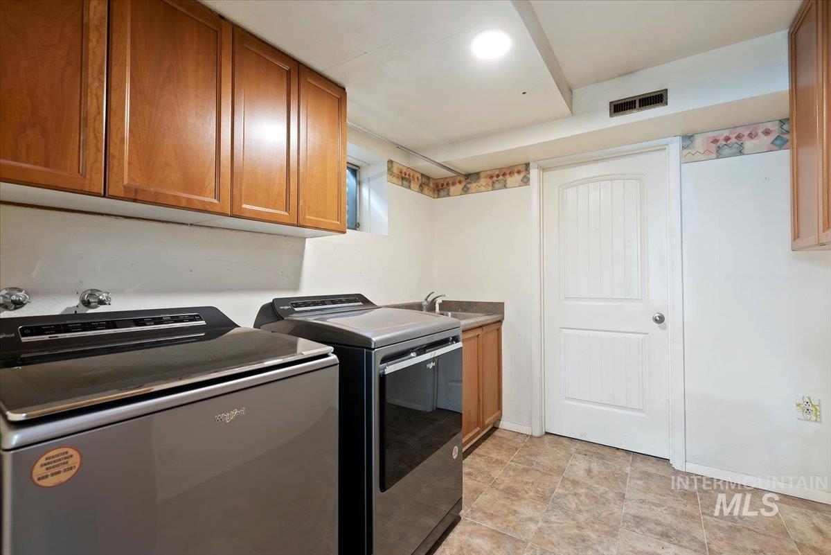 Downstairs Laundry area washer and dryer and cabinet space