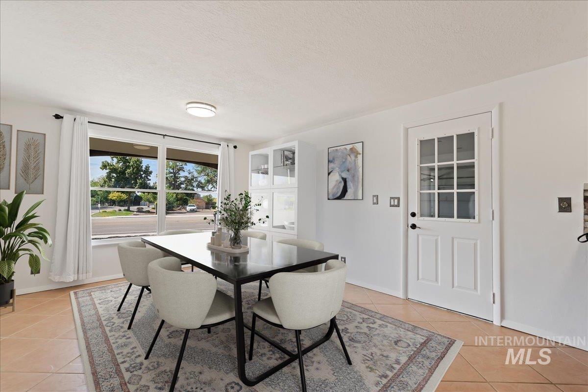 Dining room featuring a textured ceiling and light tile patterned floors