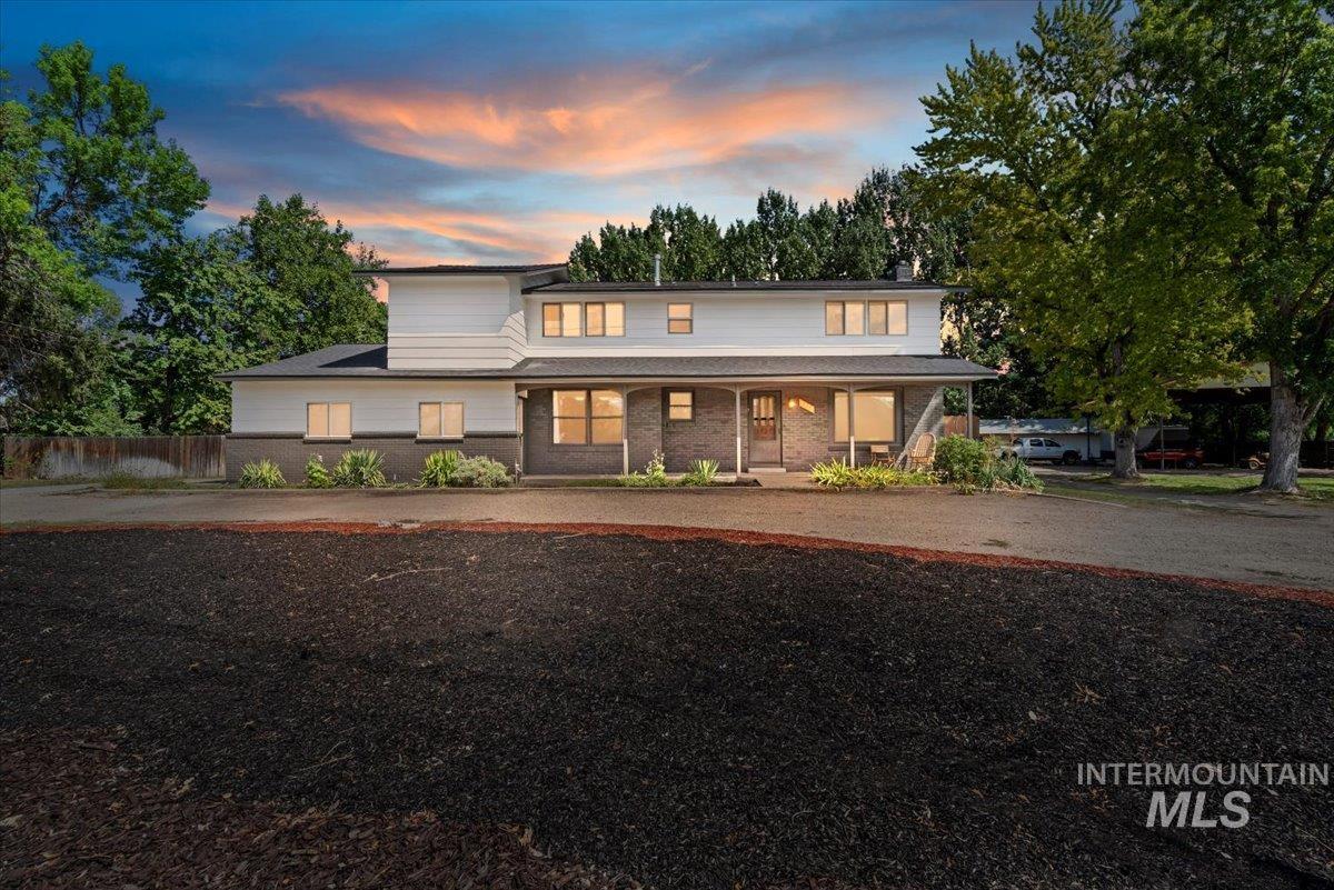 View of front of property with a porch and brick siding
