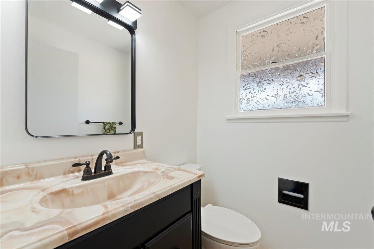 Half bath featuring vanity and toilet