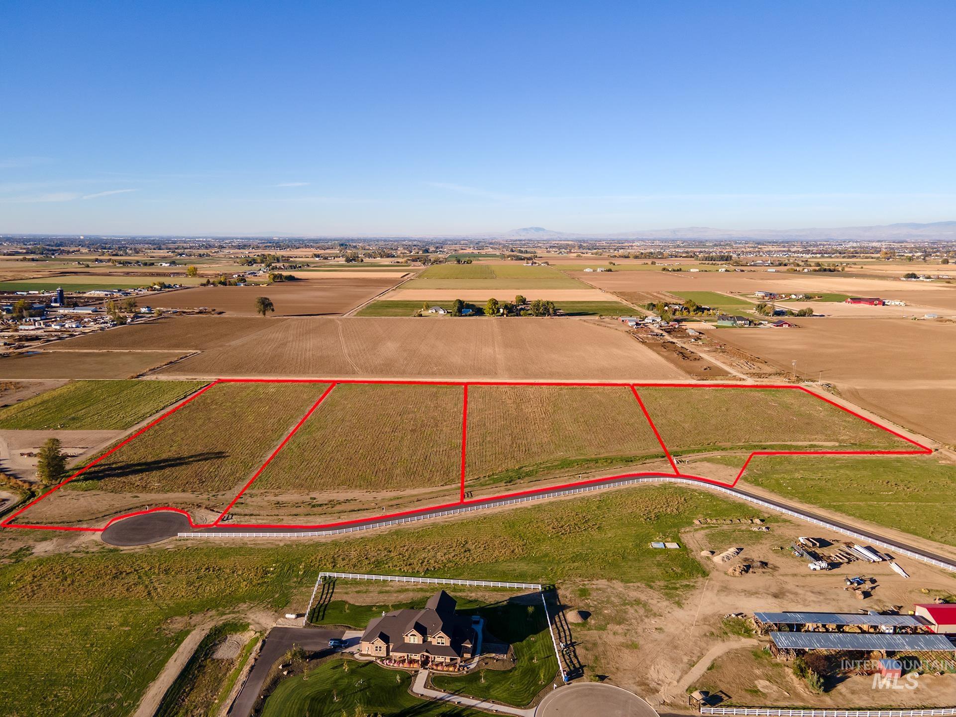Overview of rural landscape with property boundaries highlighted and mountains
