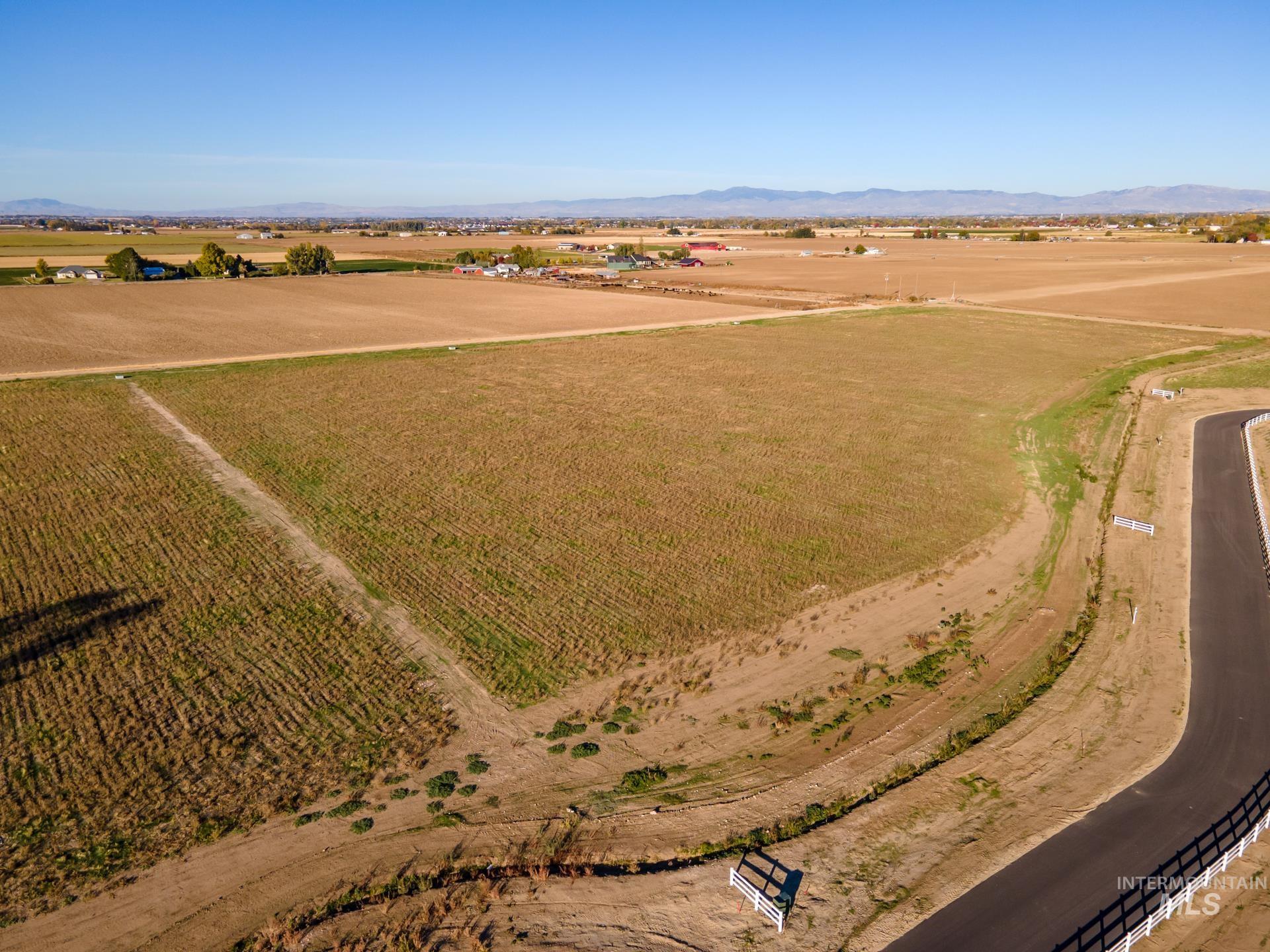 View of property location with rural landscape, a mountain backdrop, and abundant farmland