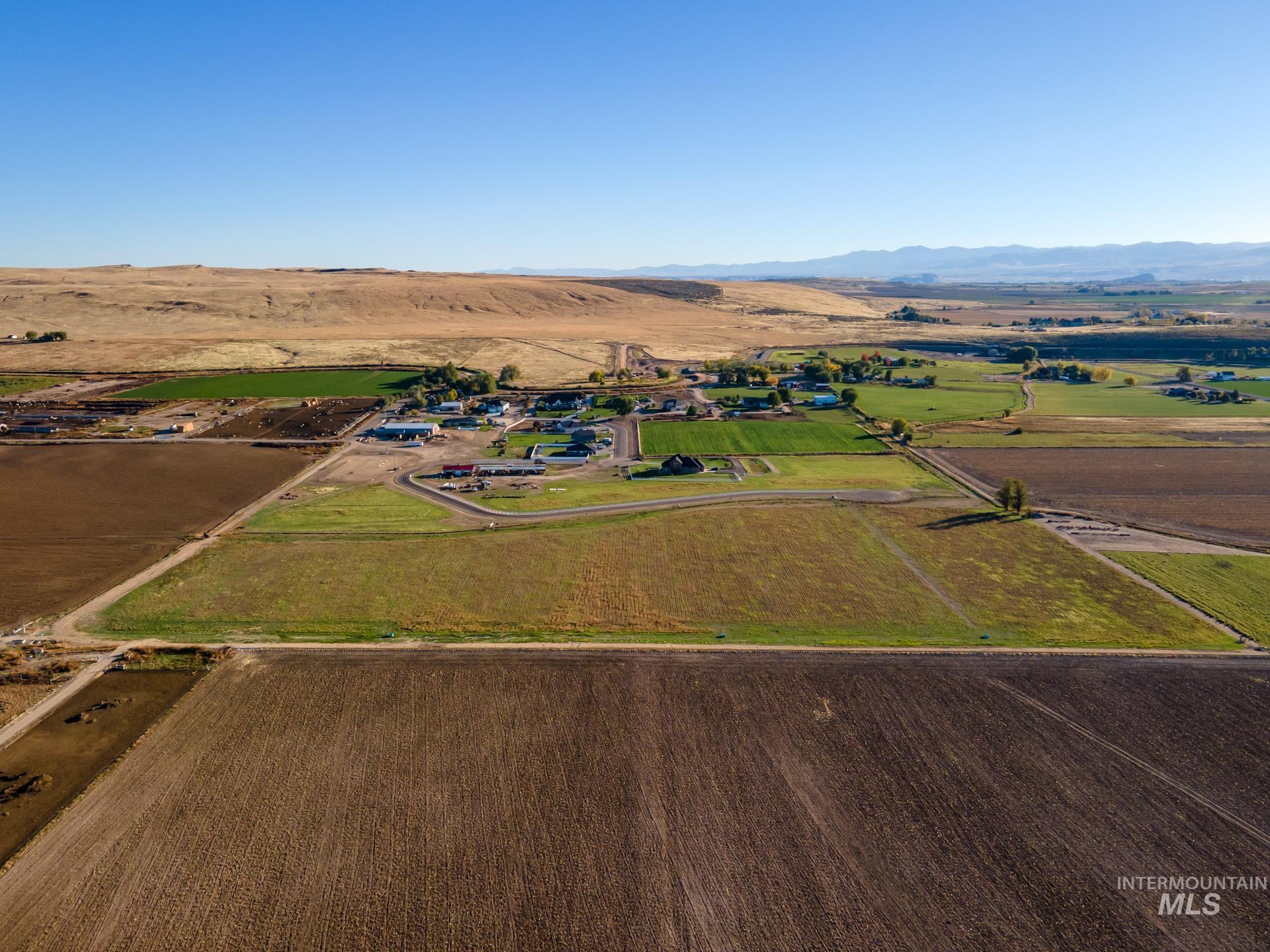 Overview of rural landscape with mountains and rows of crops