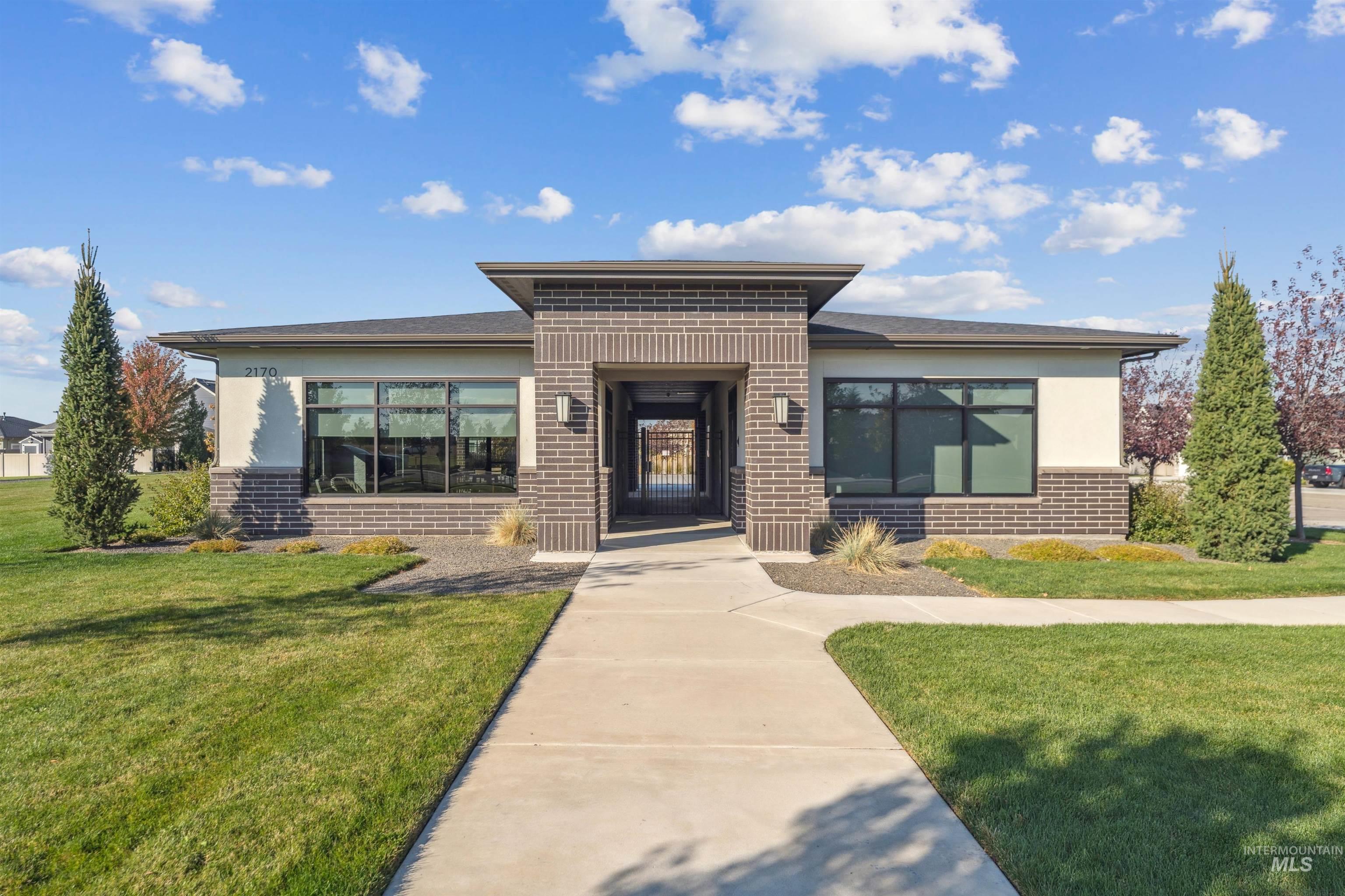 View of front of home with brick siding and a front lawn