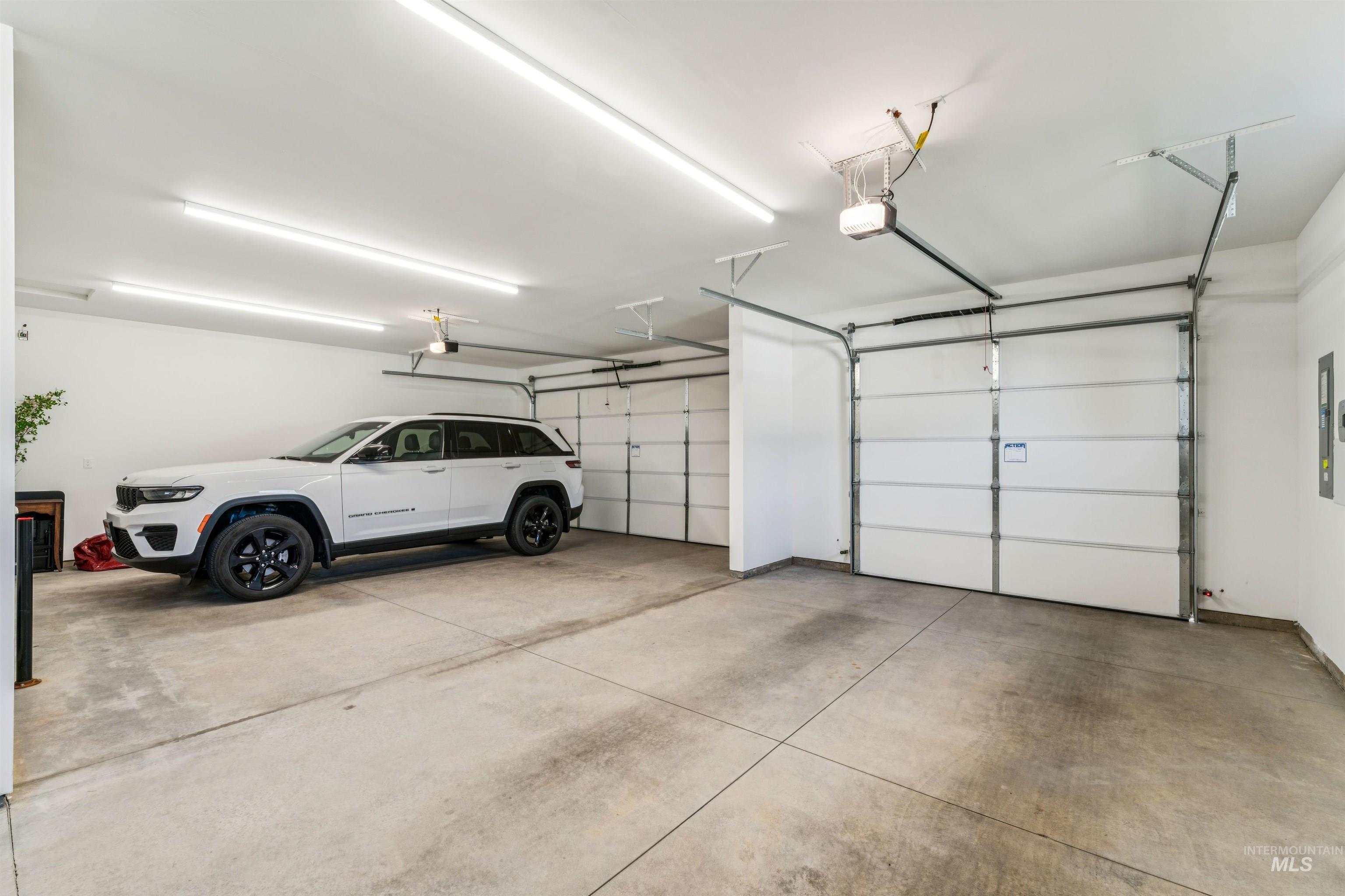 Garage featuring electric panel and a garage door opener