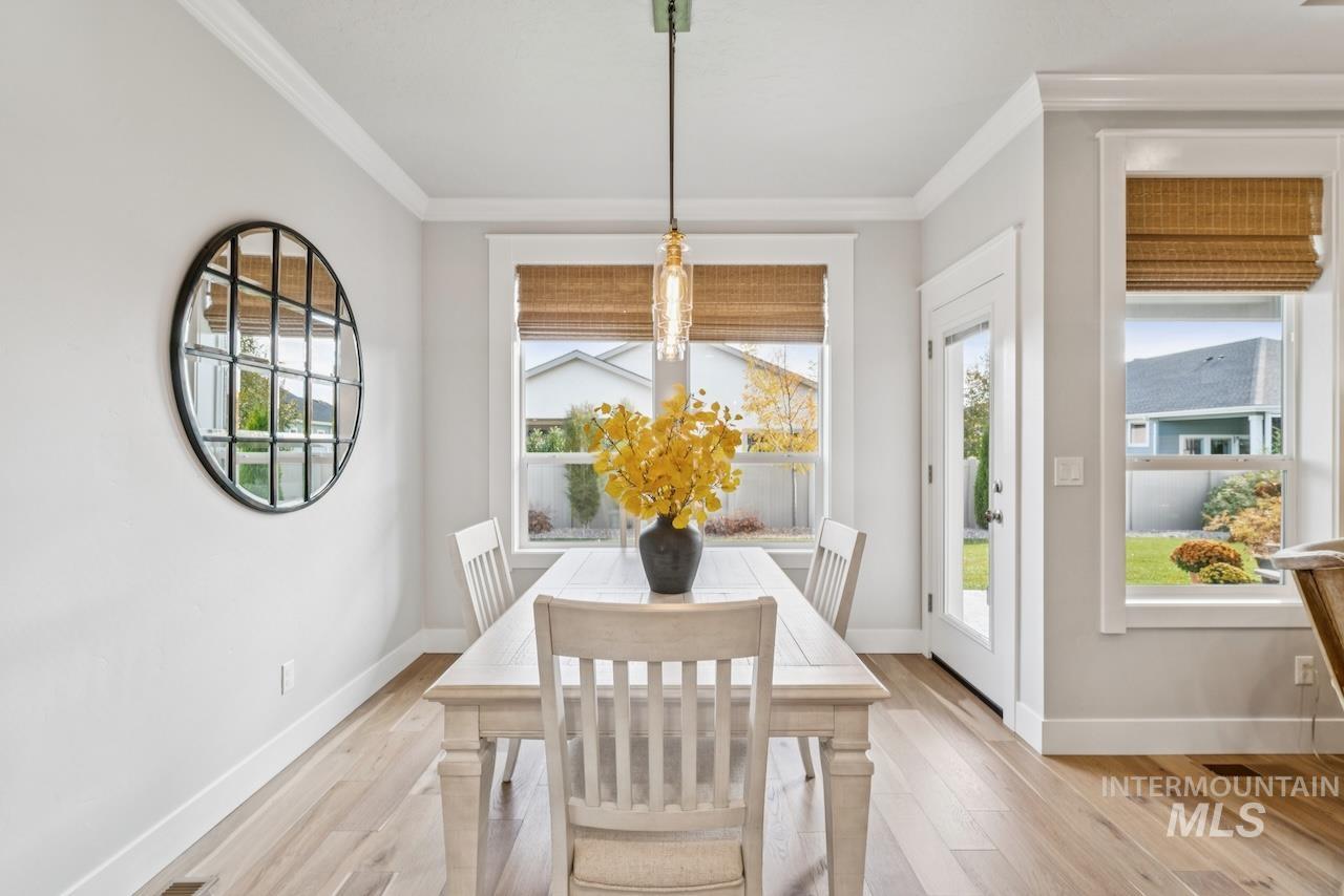 Dining room featuring crown molding and light wood-style flooring