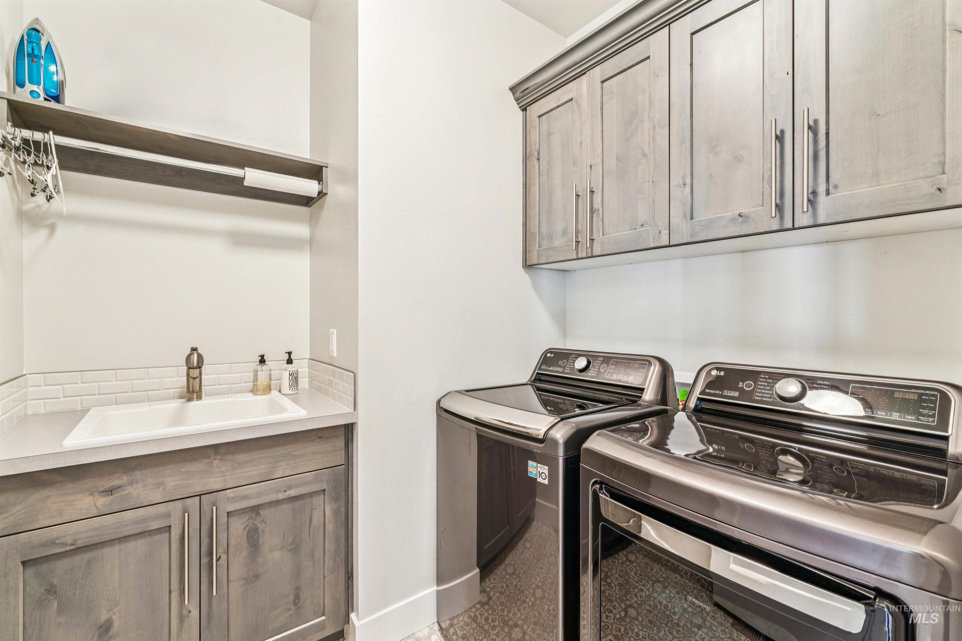 Laundry area featuring cabinet space and separate washer and dryer
