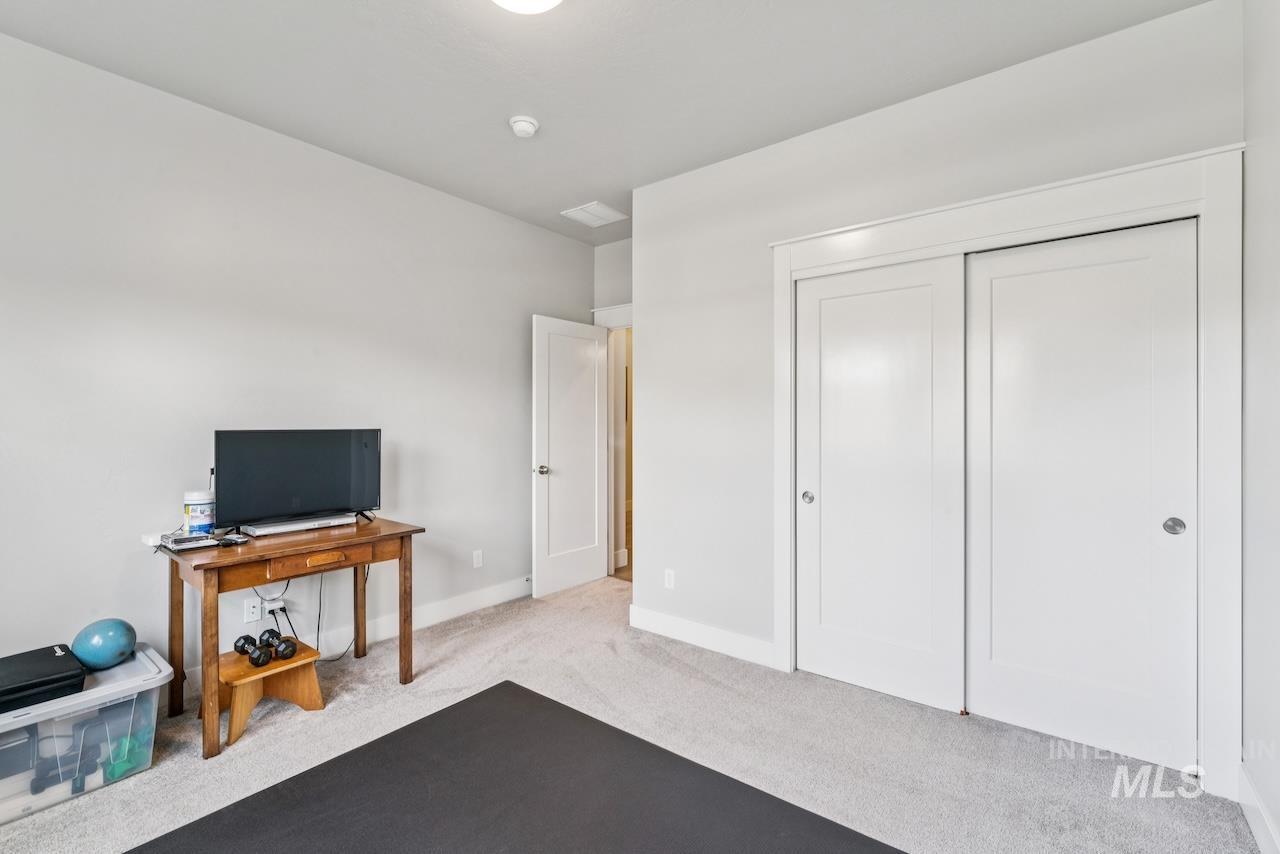 Workout room with carpet and baseboards