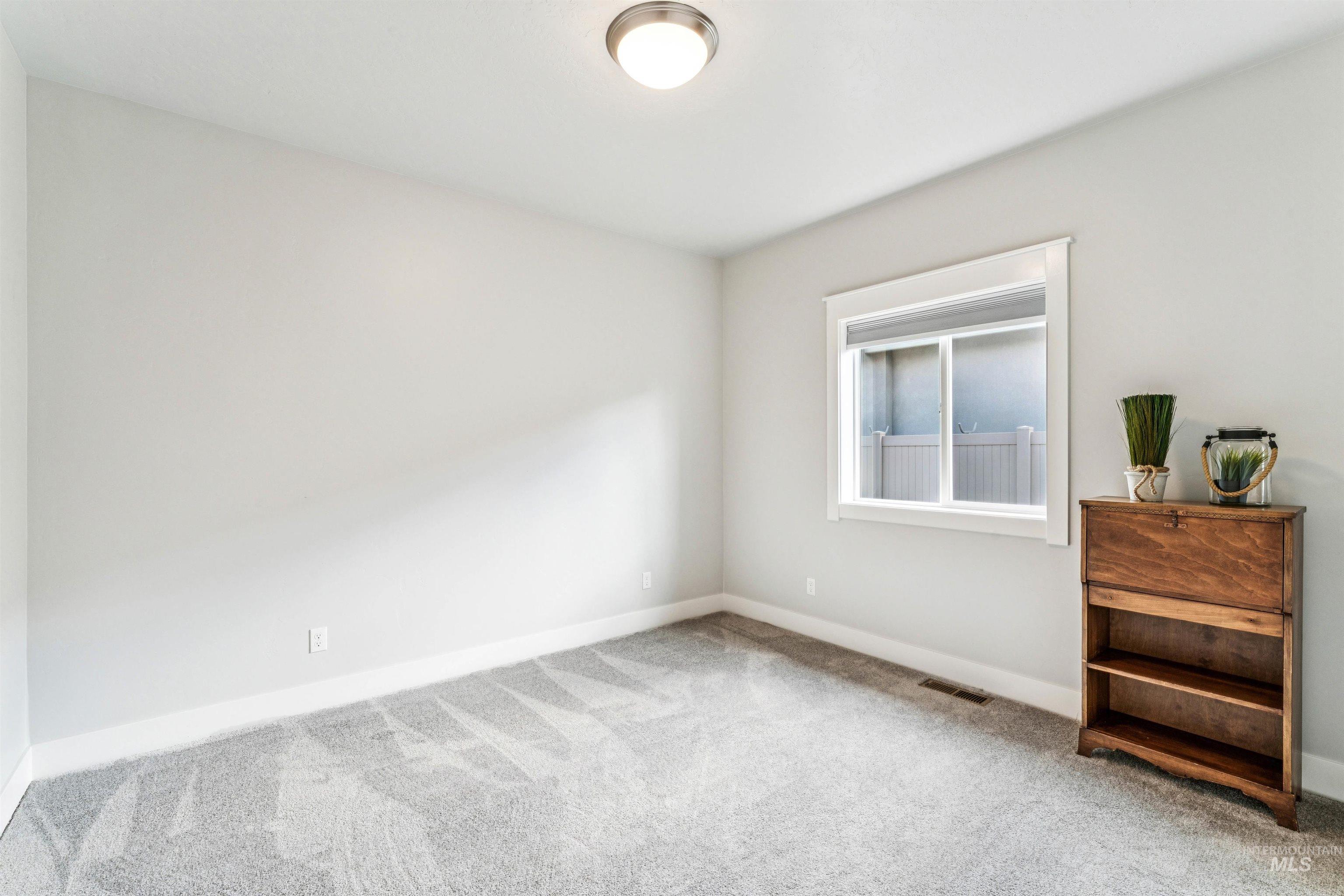 Unfurnished bedroom featuring carpet floors and baseboards
