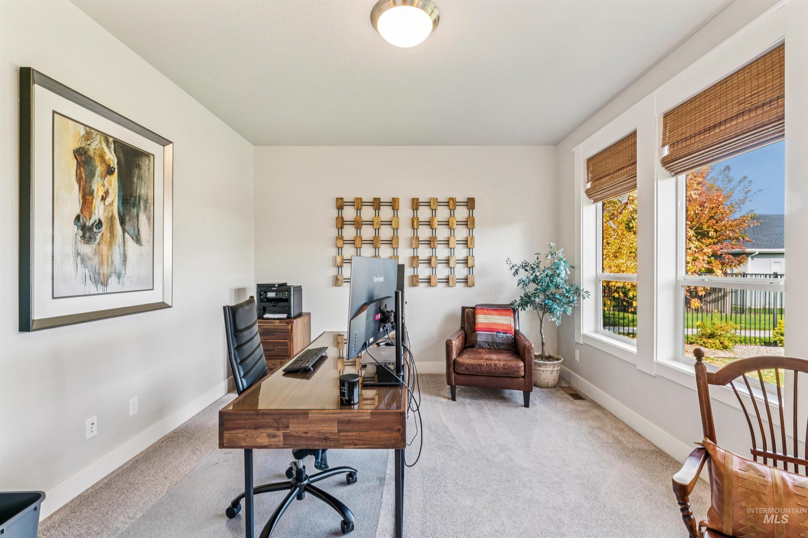 Office with carpet floors and baseboards