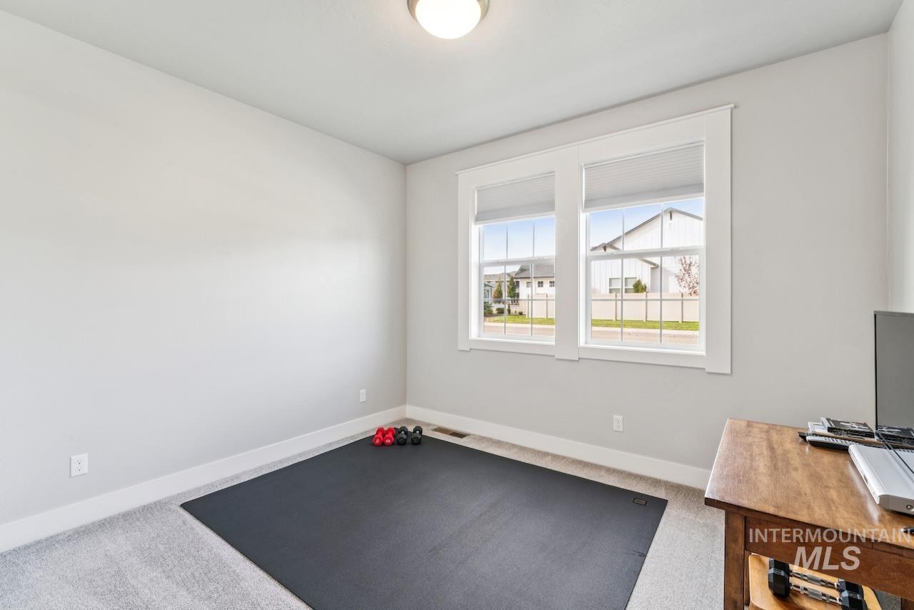 Workout area with carpet and baseboards