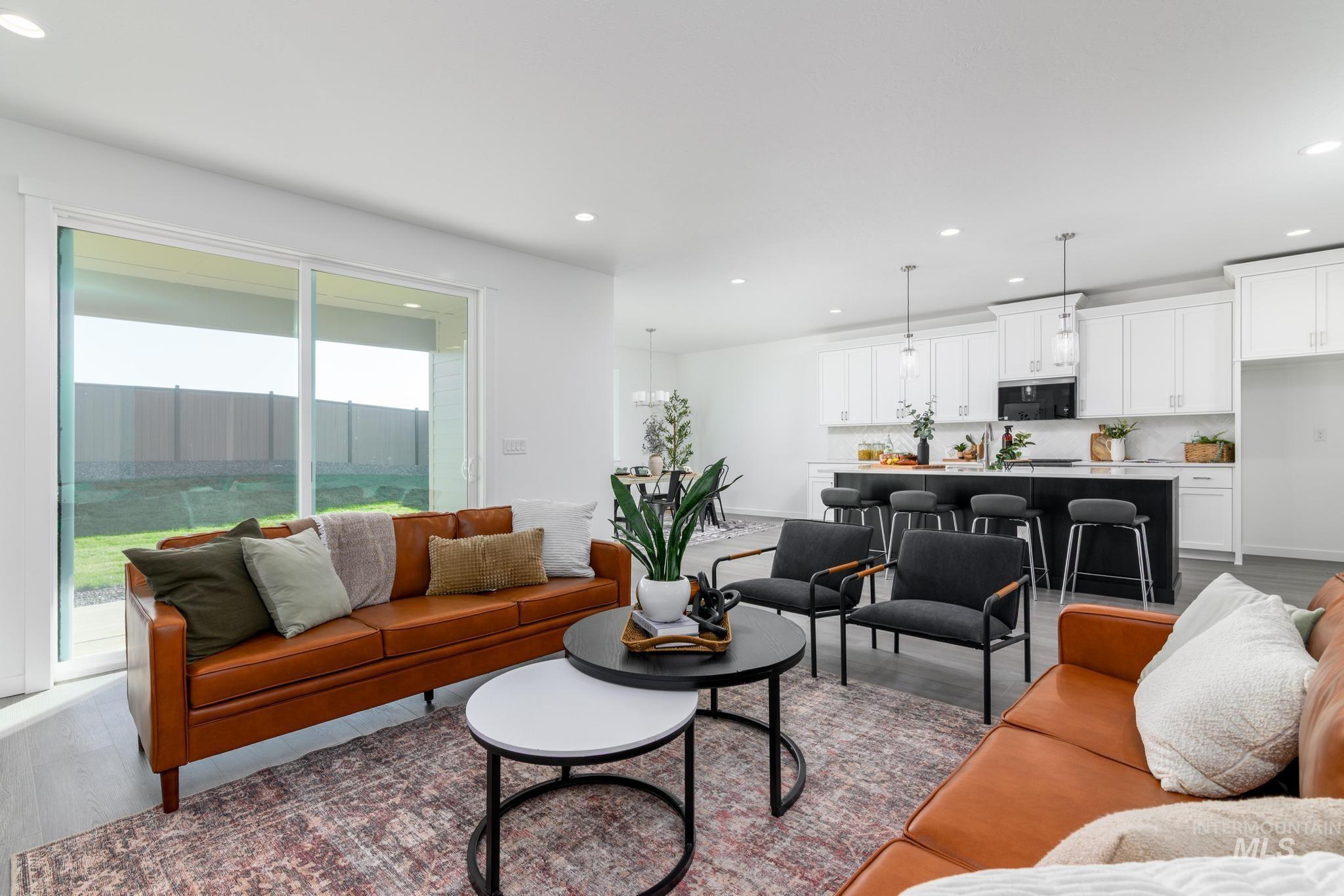 Living area featuring dark wood-style flooring and recessed lighting