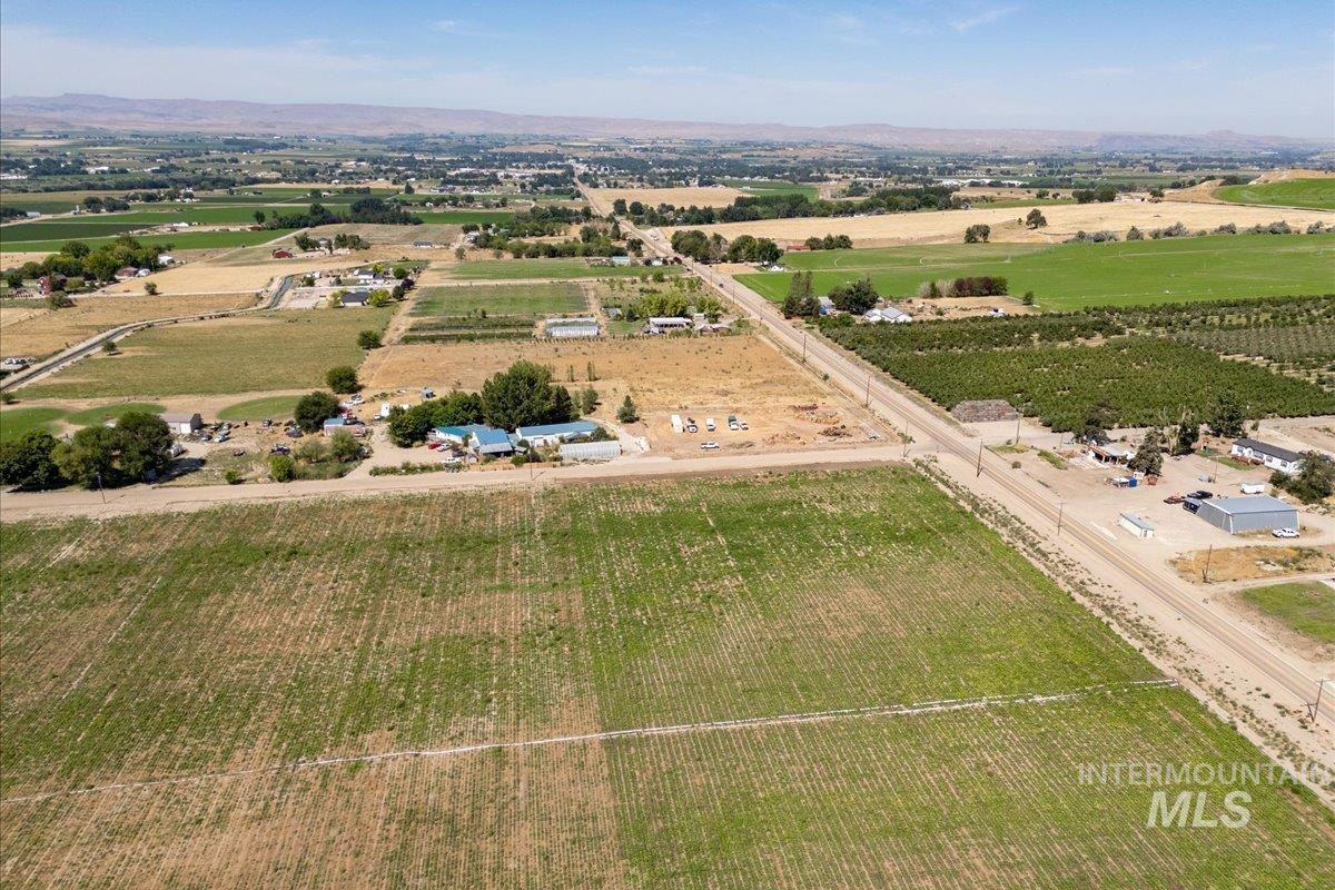 Overview of rural landscape featuring abundant farmland and a mountain backdrop
