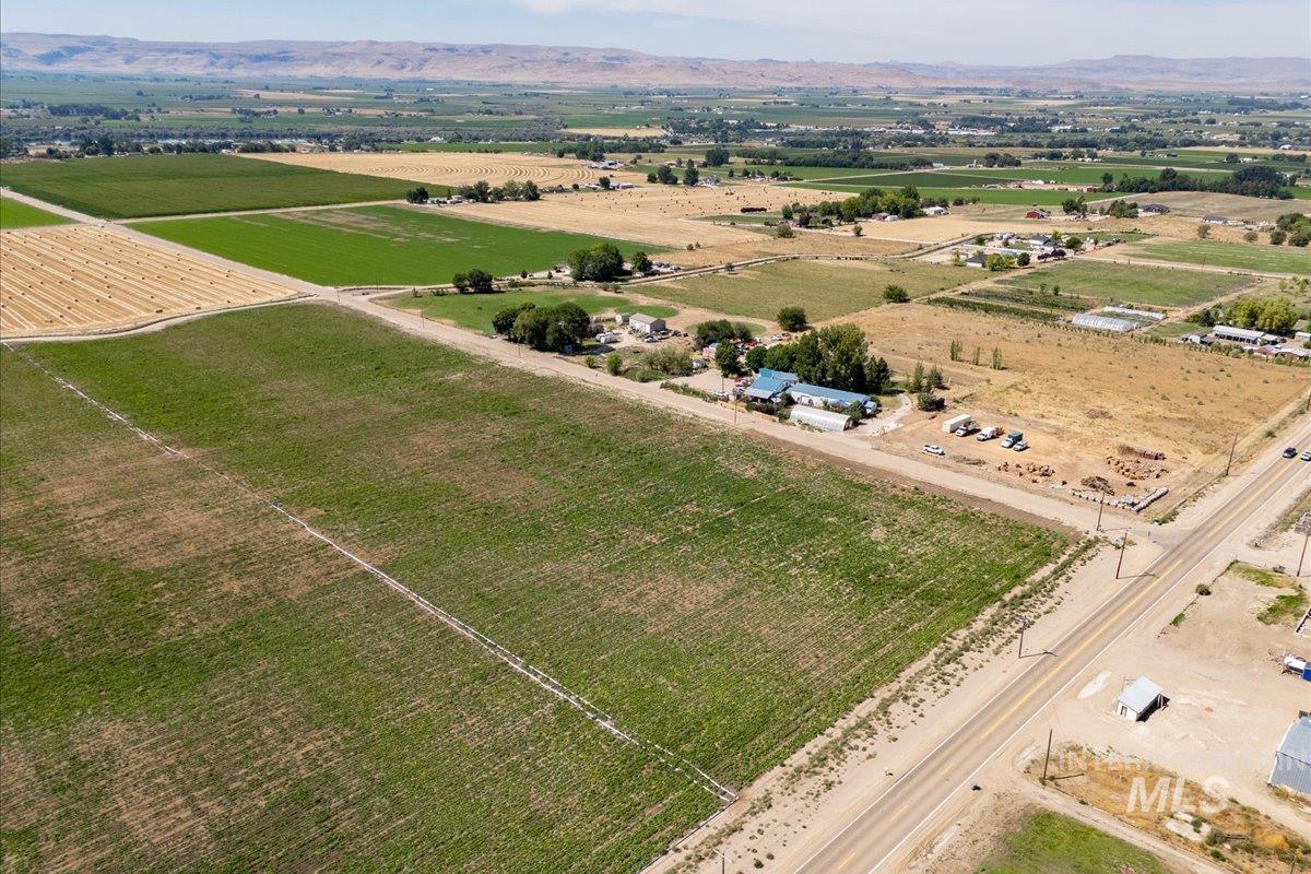 Overview of rural landscape featuring extensive farmland and a mountain backdrop