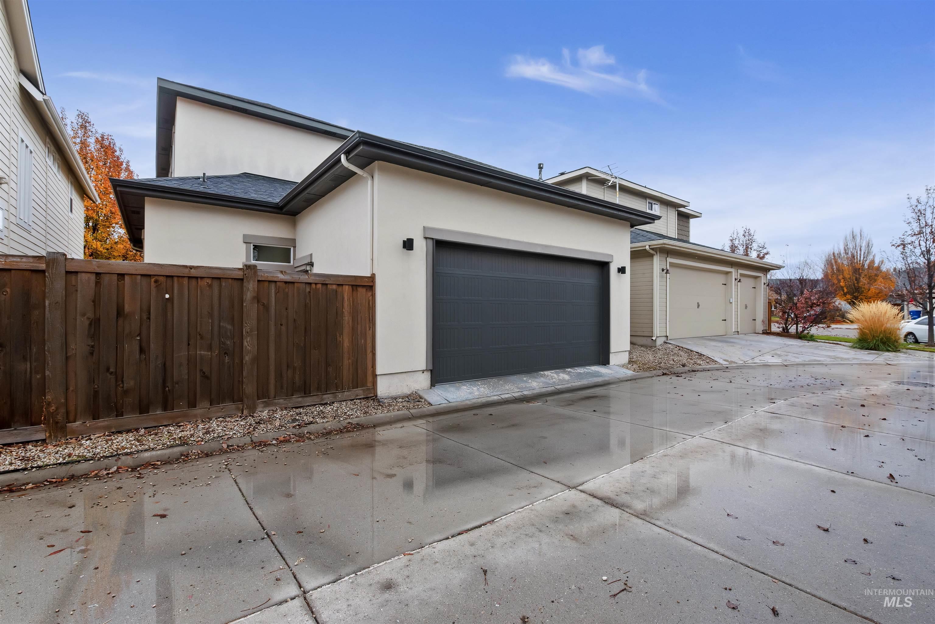 View of side of property with stucco siding and concrete driveway