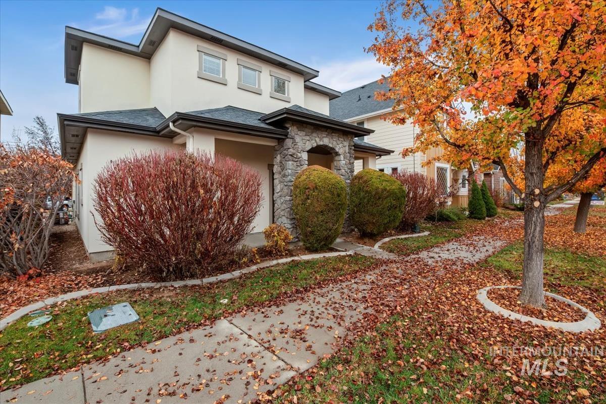 View of front of house featuring stucco siding and stone siding