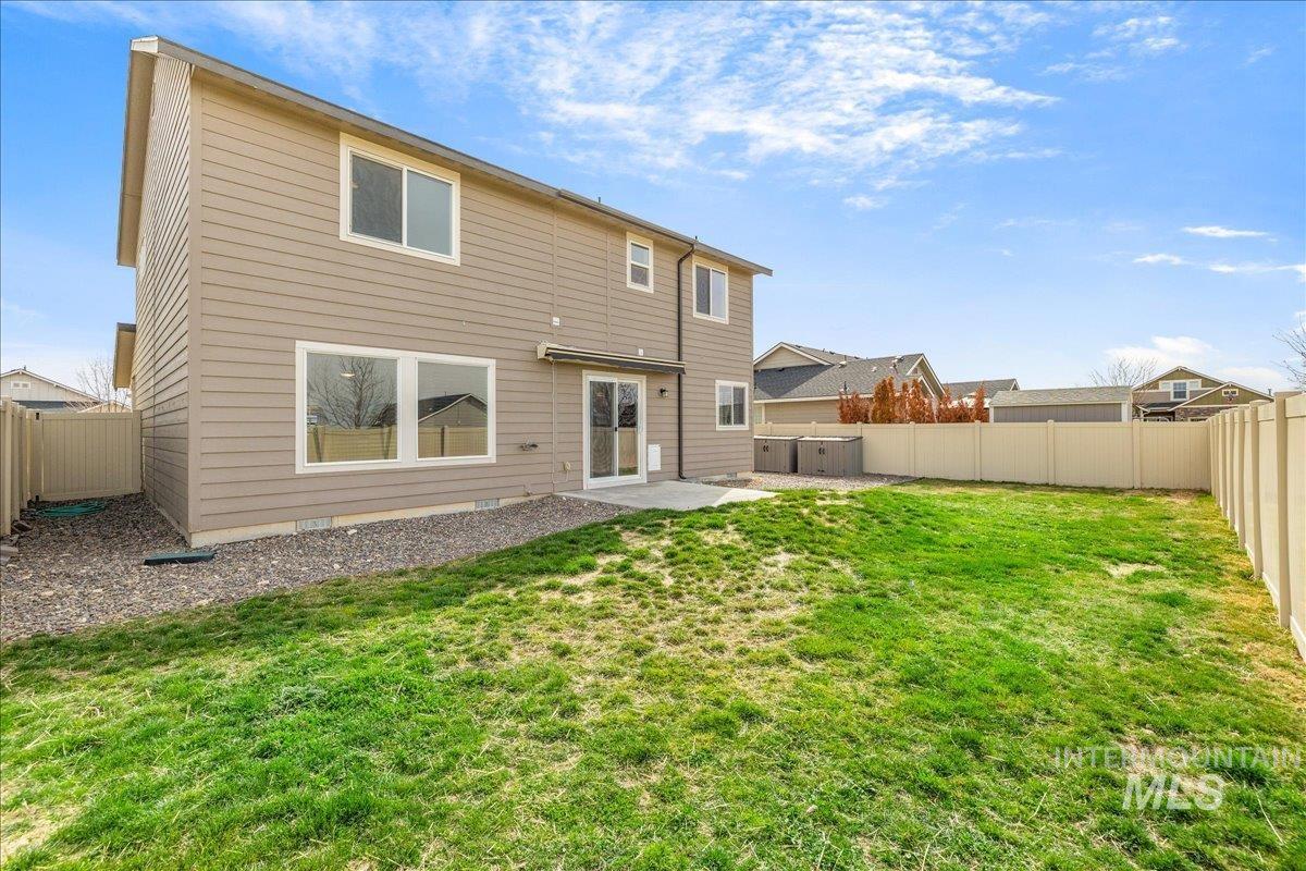 Back of property with a patio area and a fenced backyard