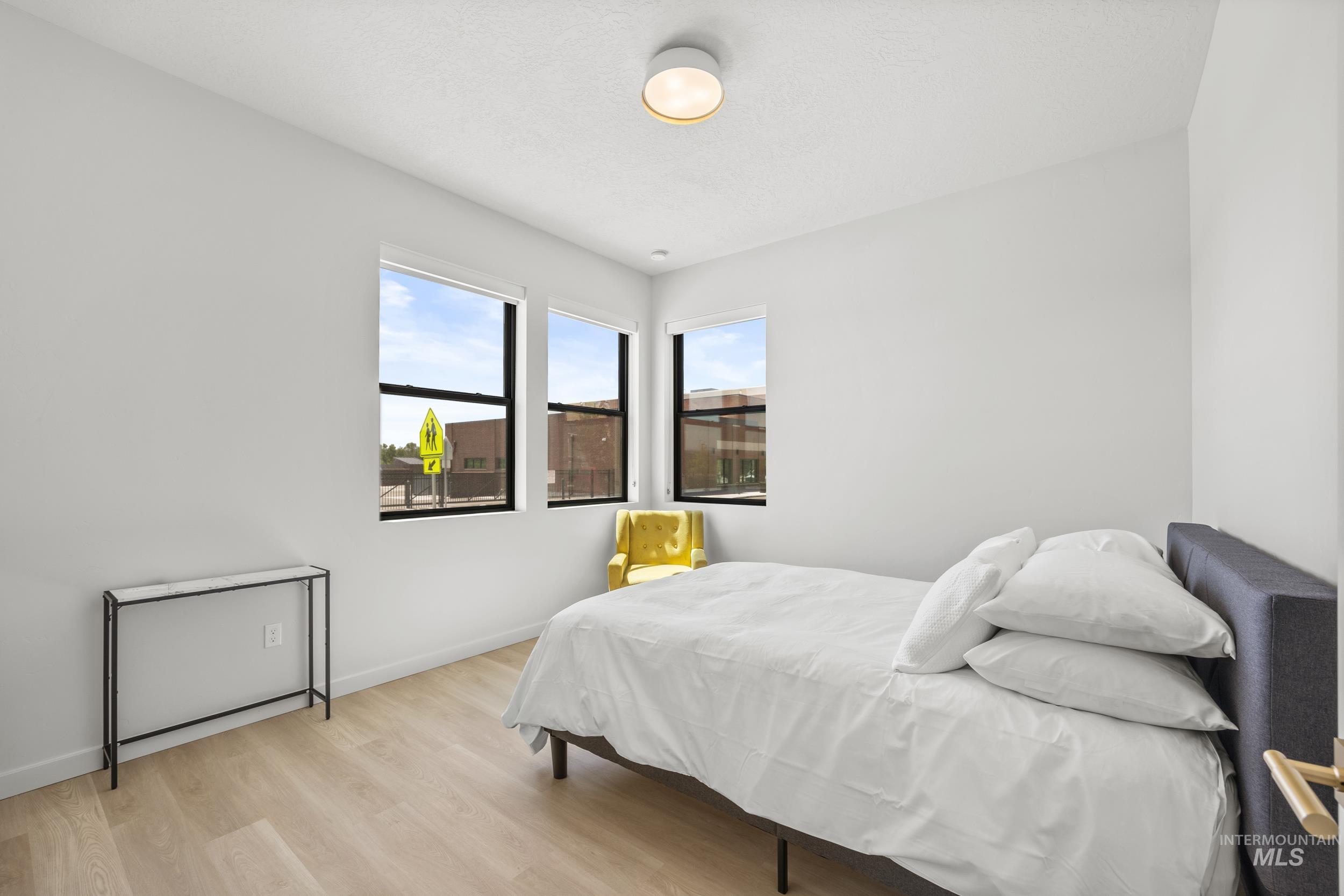 Bedroom with light wood-style flooring and baseboards