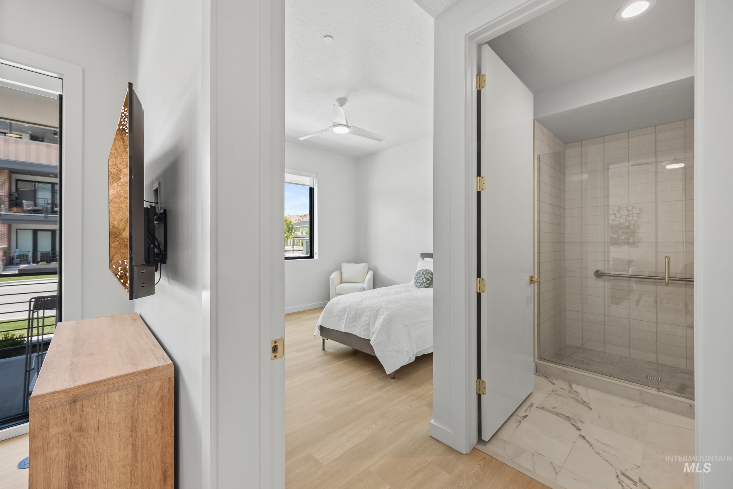 Bedroom featuring connected bathroom and light wood-style floors