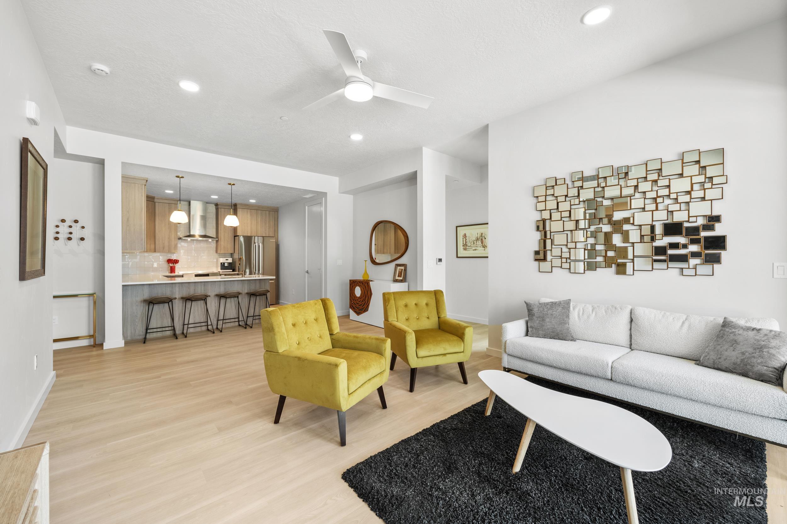 Living room with recessed lighting, light wood-type flooring, and ceiling fan