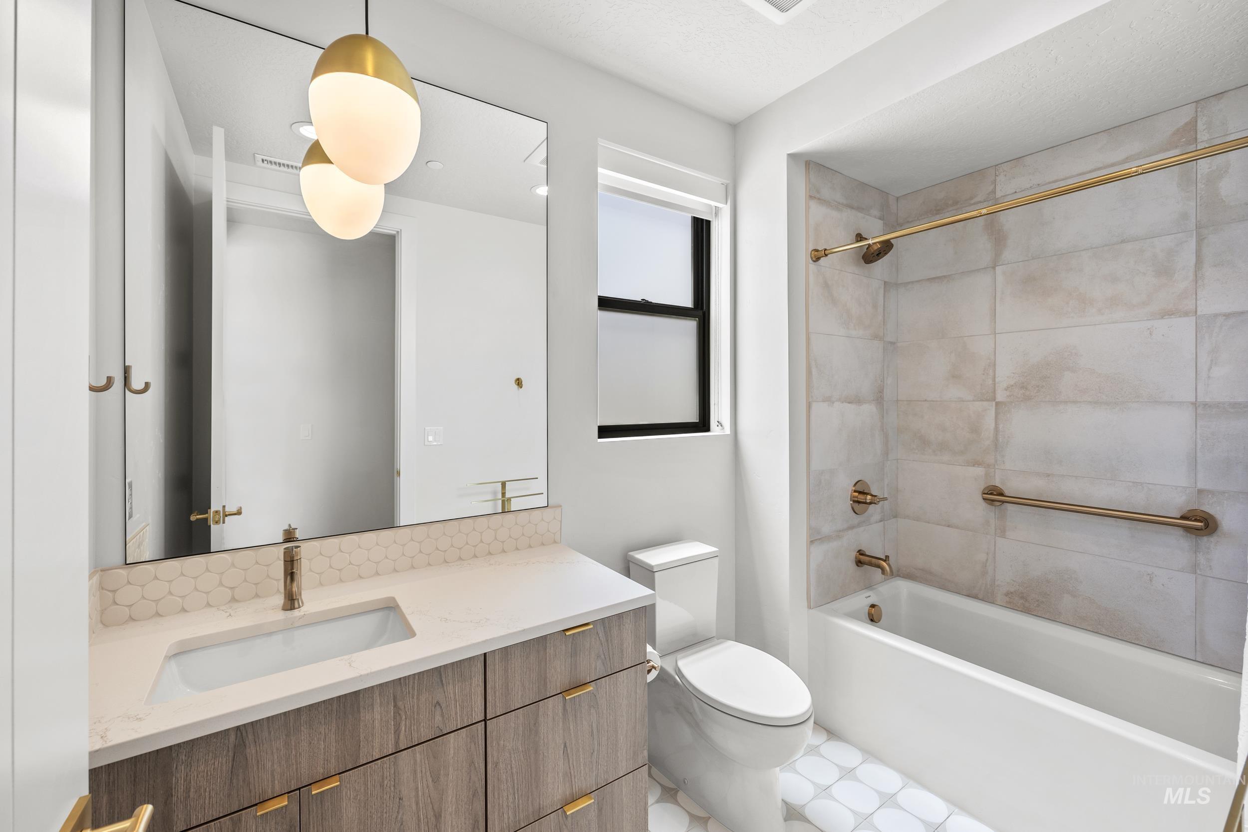 Bathroom with vanity and shower / tub combination