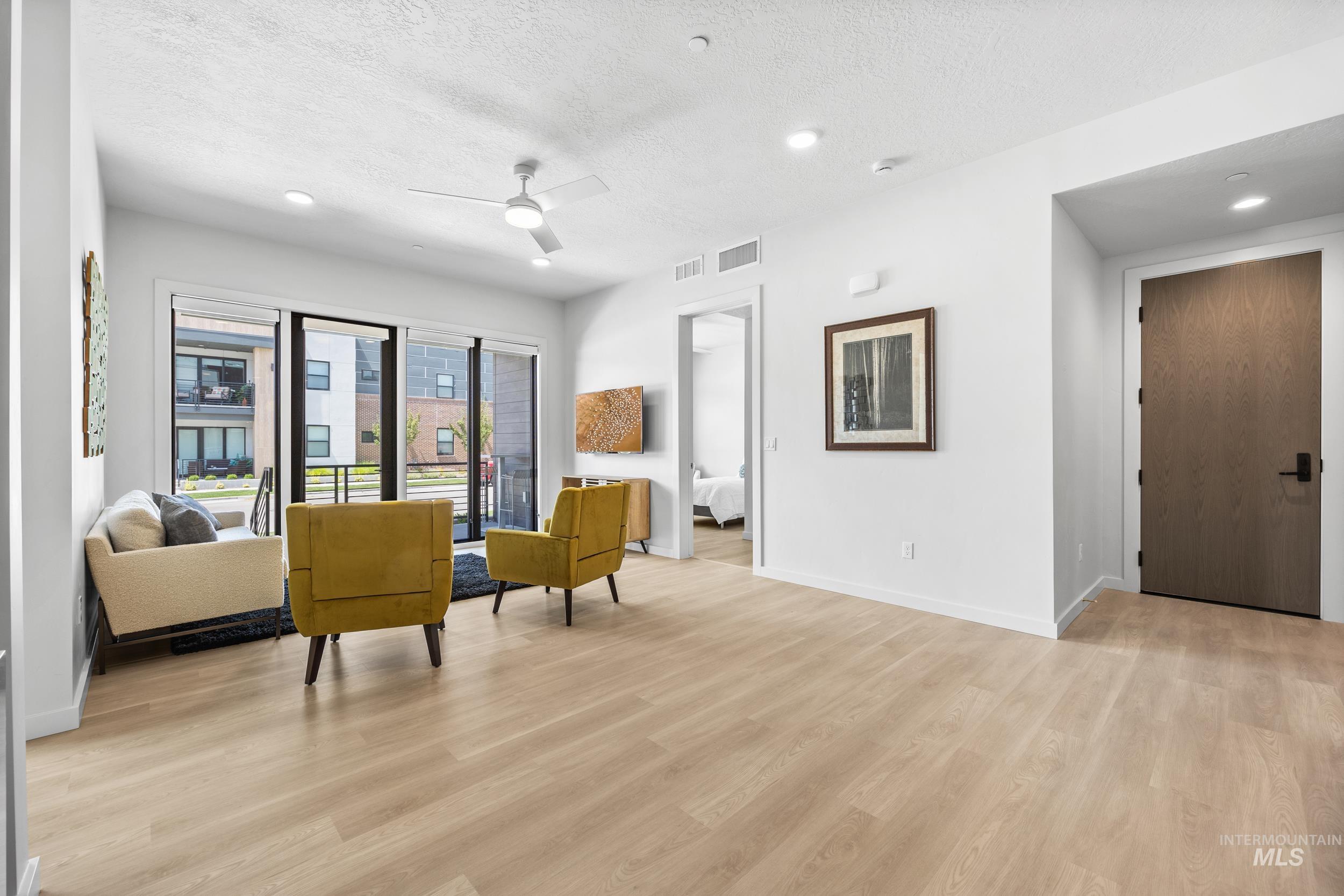 Sitting room featuring recessed lighting, a textured ceiling, ceiling fan, and light wood-type flooring