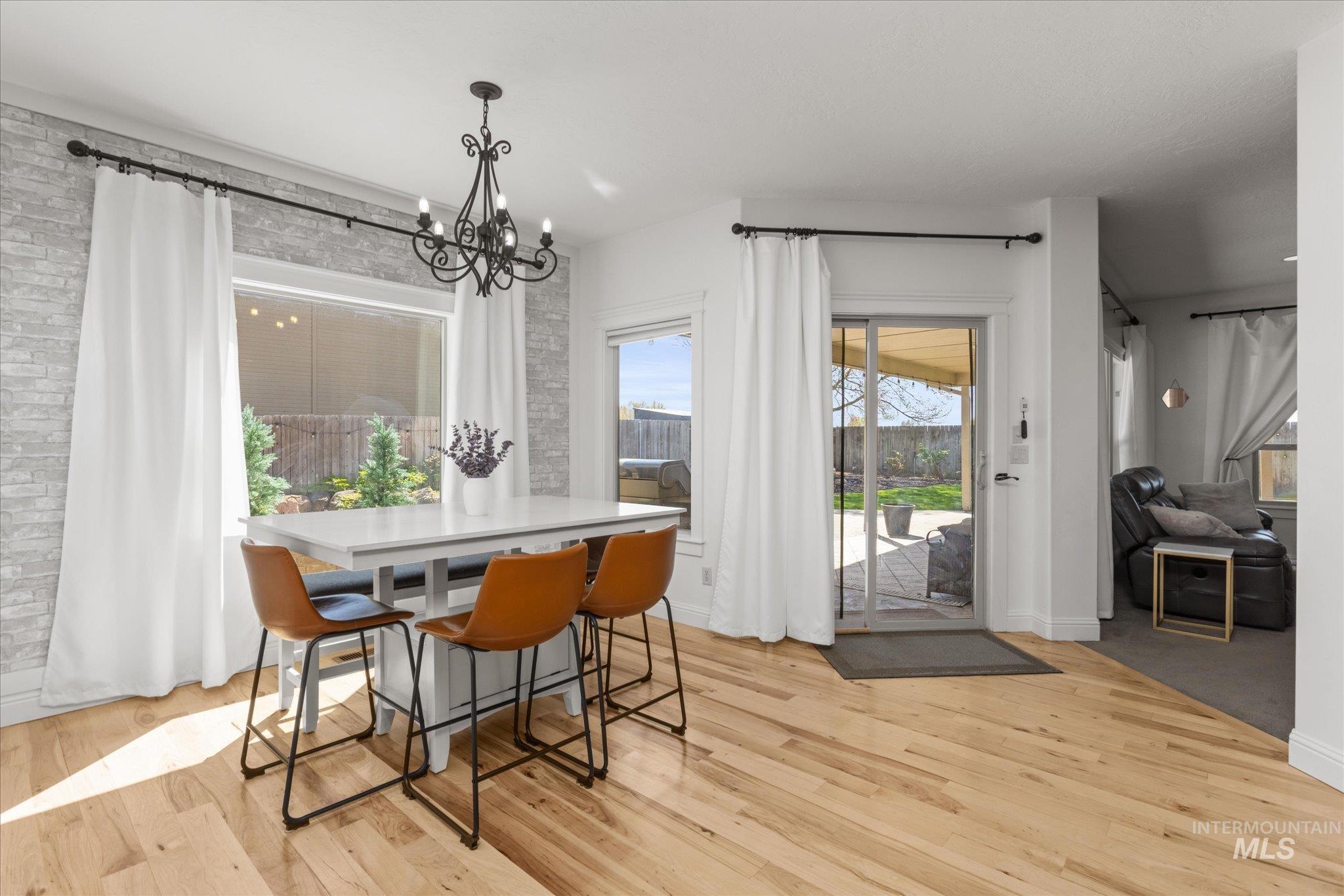 Dining area with light wood-finish flooring
