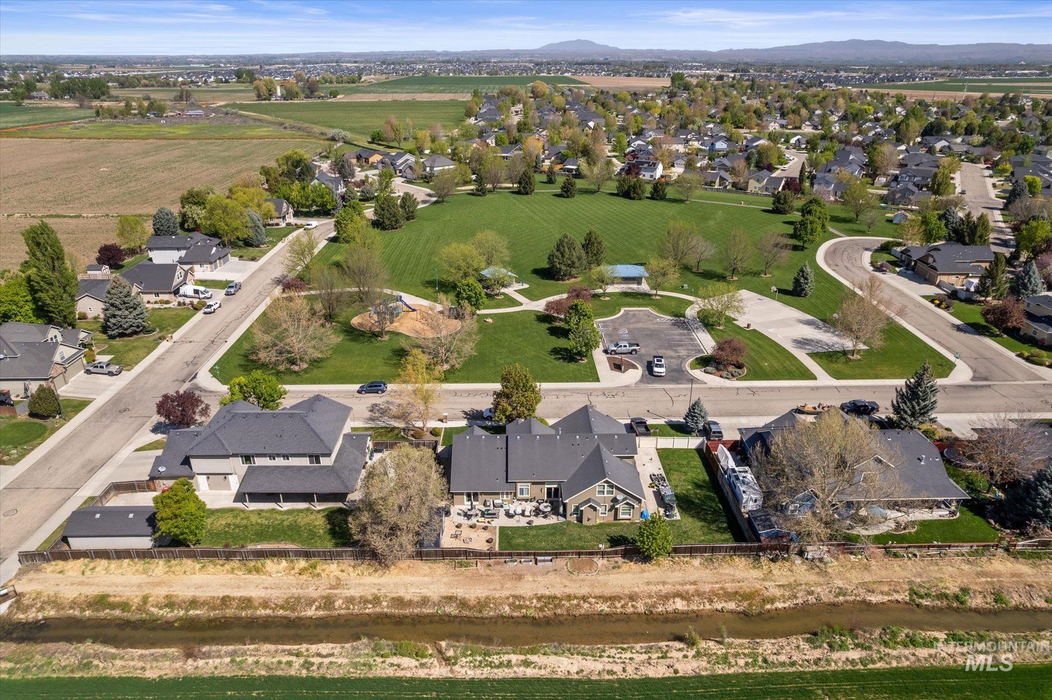Aerial perspective showcasing an established suburban community with a large central park area