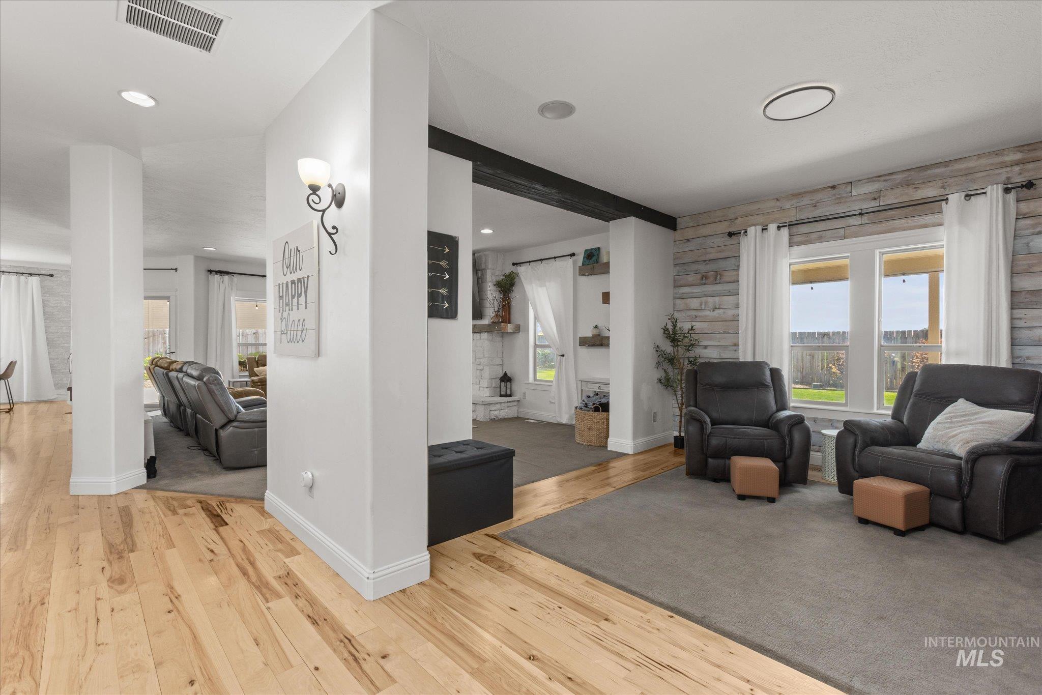 Bright interior space featuring wood-finish flooring, recessed lighting, and a textured accent wall