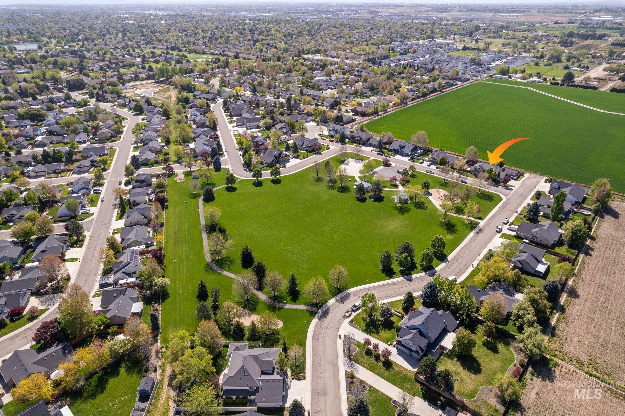 Residential neighborhood featuring a central green space with walking paths