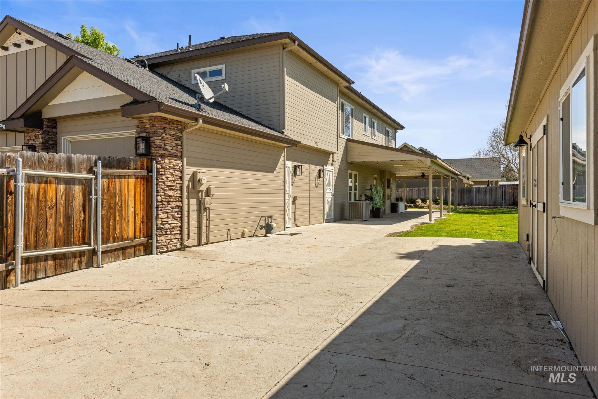 Spacious concrete driveway extending along the property