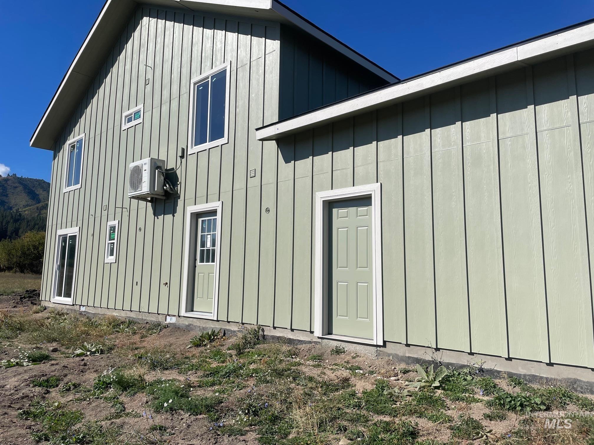 Rear view of property with board and batten siding
