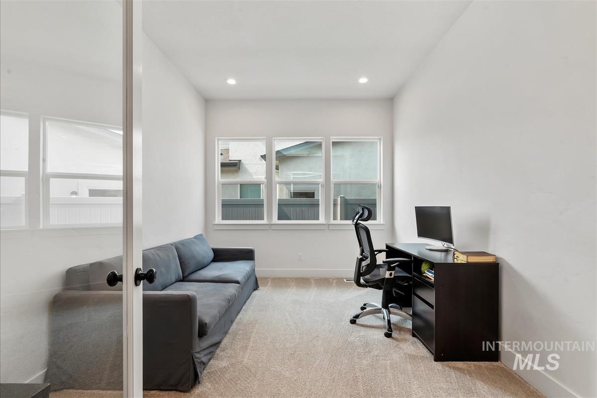 Office area featuring light colored carpet and recessed lighting
