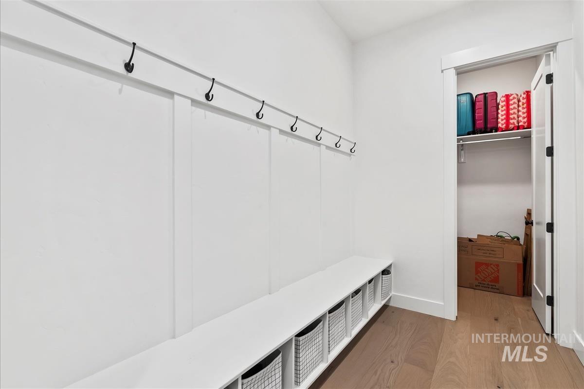 Mudroom with light wood finished floors and baseboards