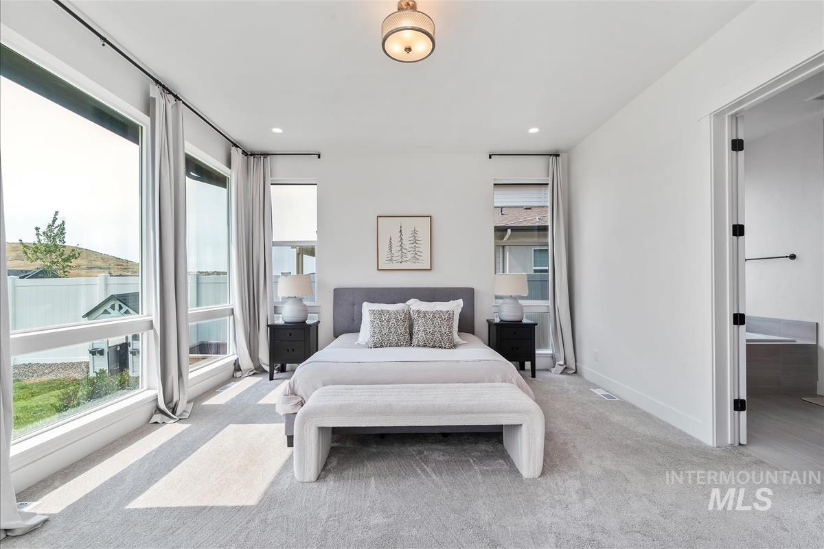 Bedroom featuring light colored carpet and recessed lighting
