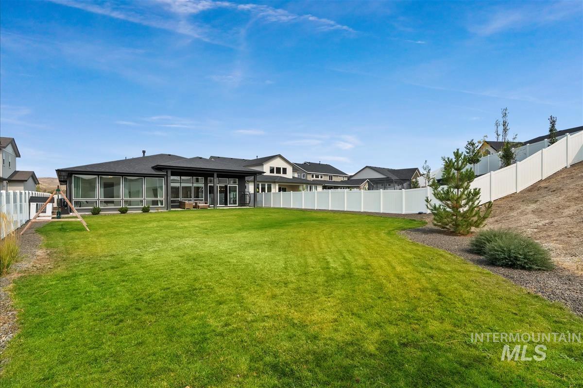 Fenced backyard with a patio area and a sunroom