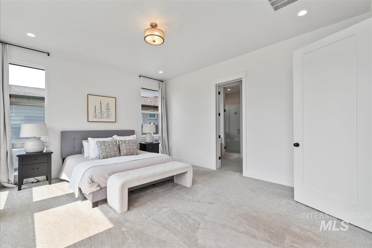 Bedroom with carpet, recessed lighting, and ensuite bath
