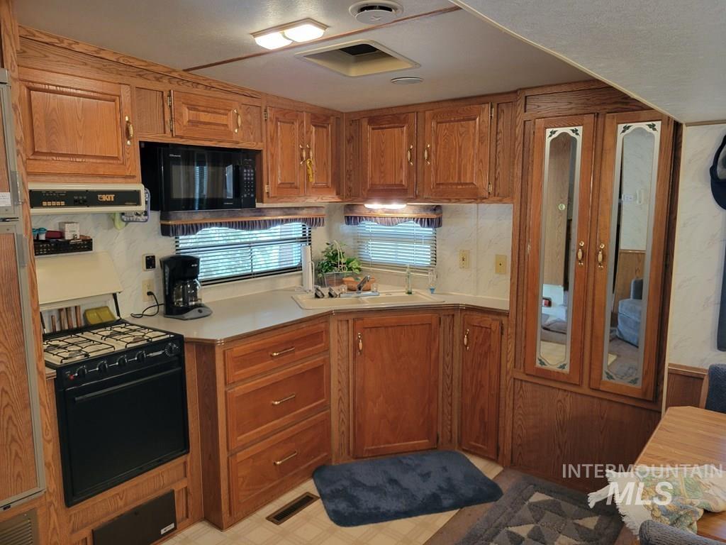 Kitchen with wood finish cabinets and light countertops