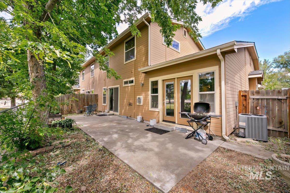 Expansive concrete patio with direct access to interior spaces through a sliding glass door and double French doors