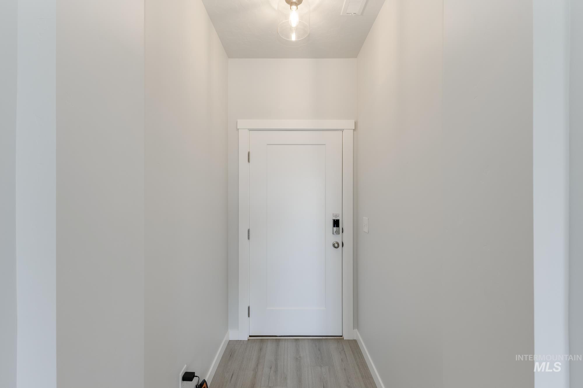 Entryway featuring wood finished floors and baseboards