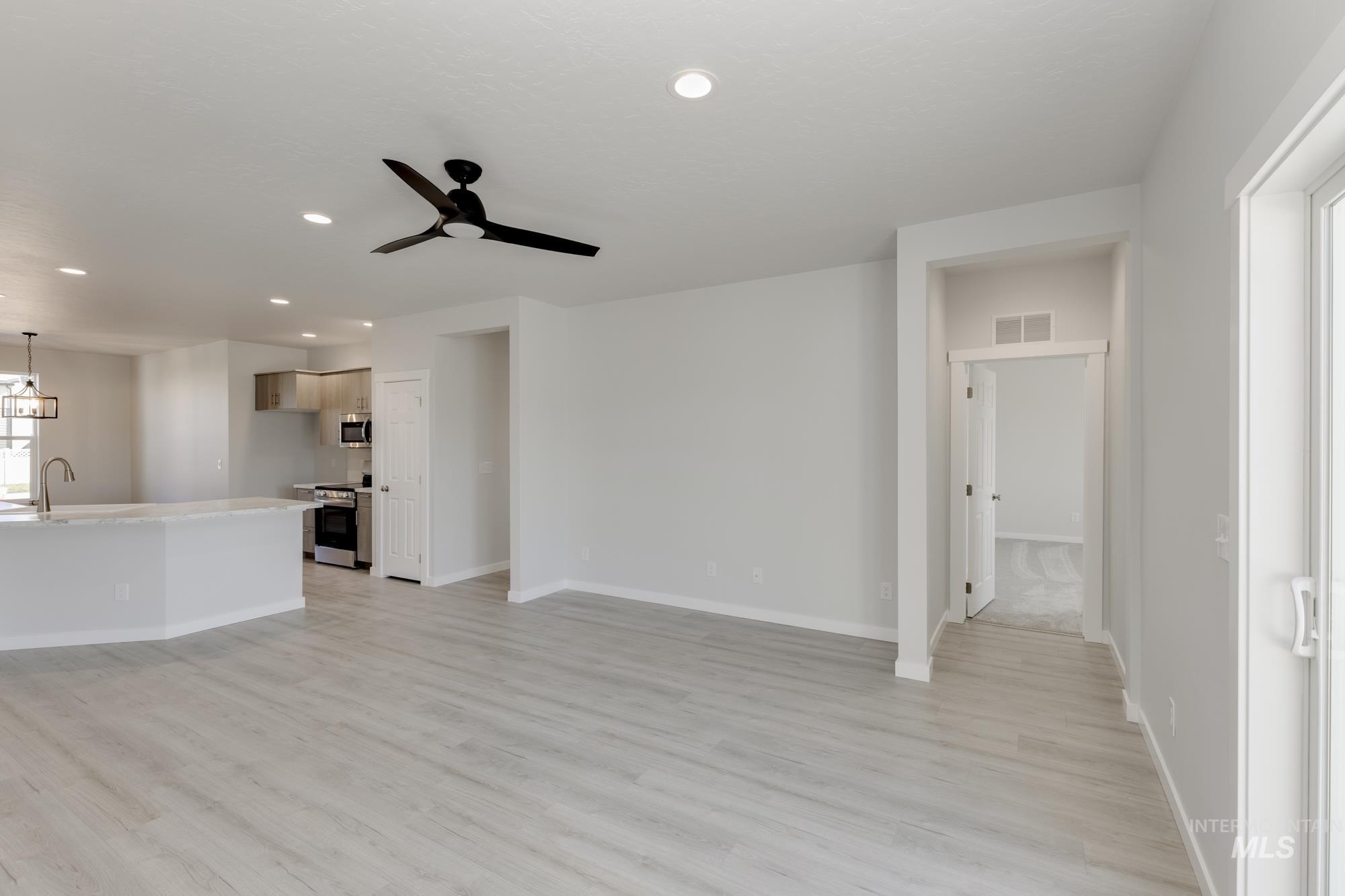 Unfurnished living room with recessed lighting, light wood finished floors, and ceiling fan