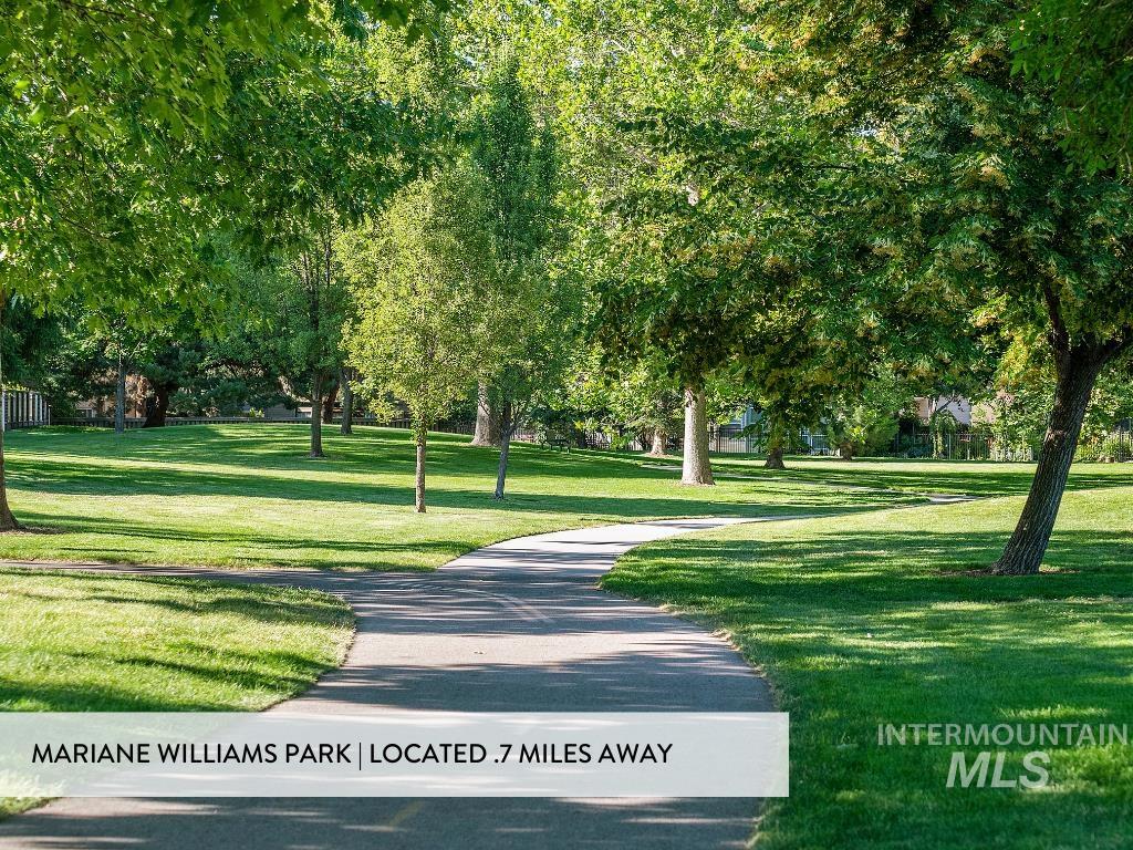 View of home's community with a lawn
