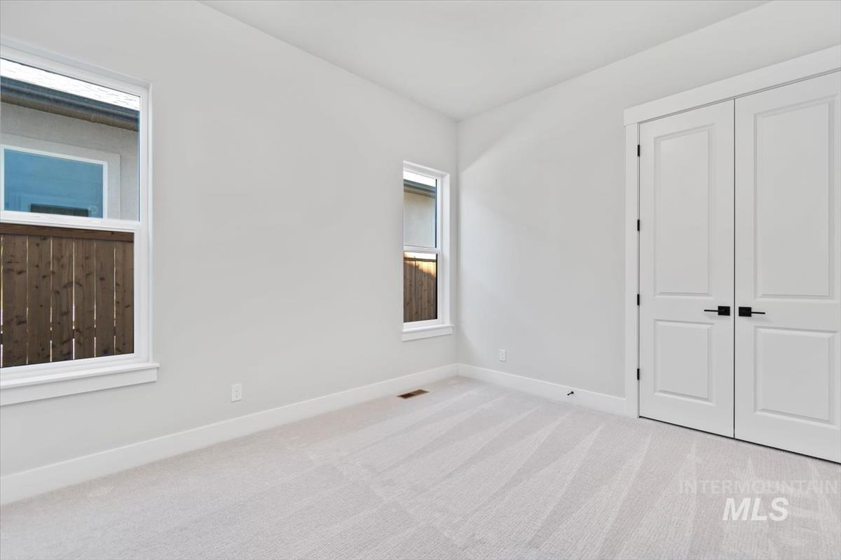 Unfurnished bedroom featuring carpet flooring and a closet