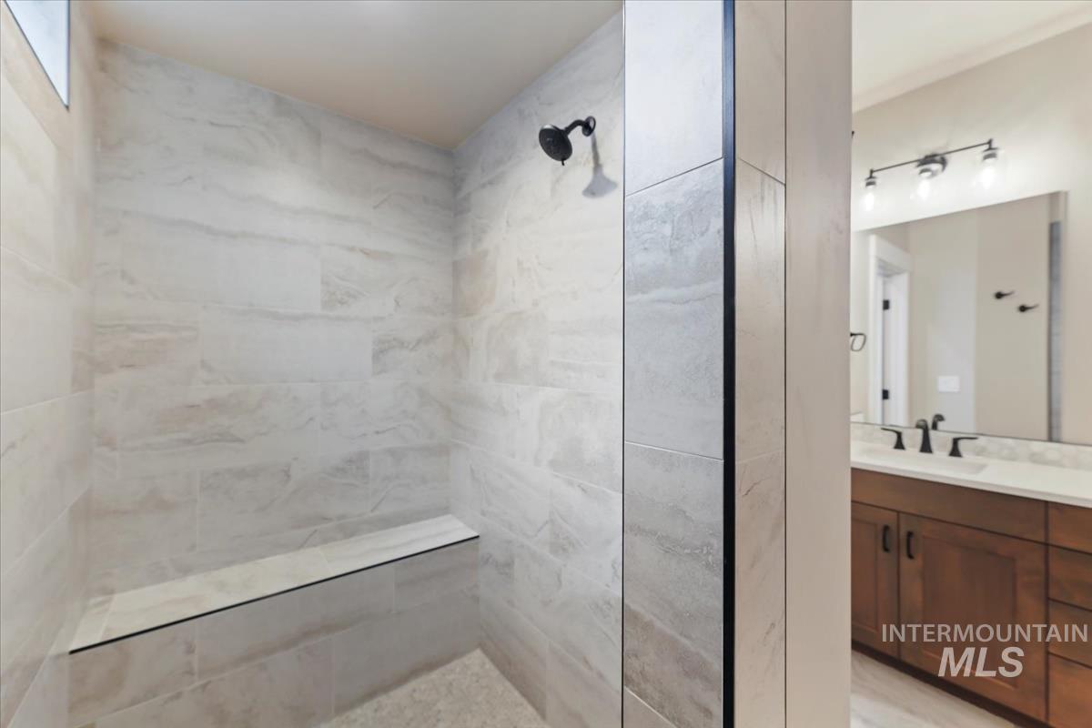 Full bathroom with vanity and tiled shower