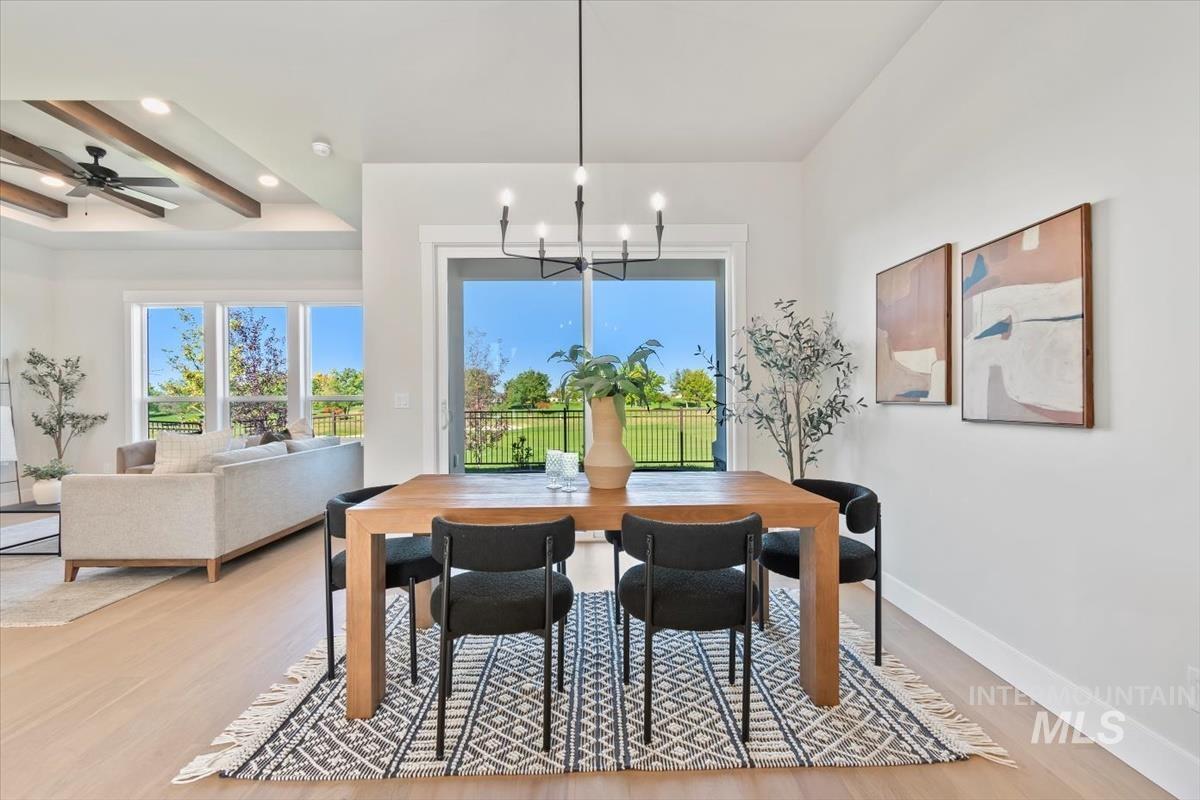 Dining space featuring light wood-type flooring, beamed ceiling, a chandelier, and recessed lighting