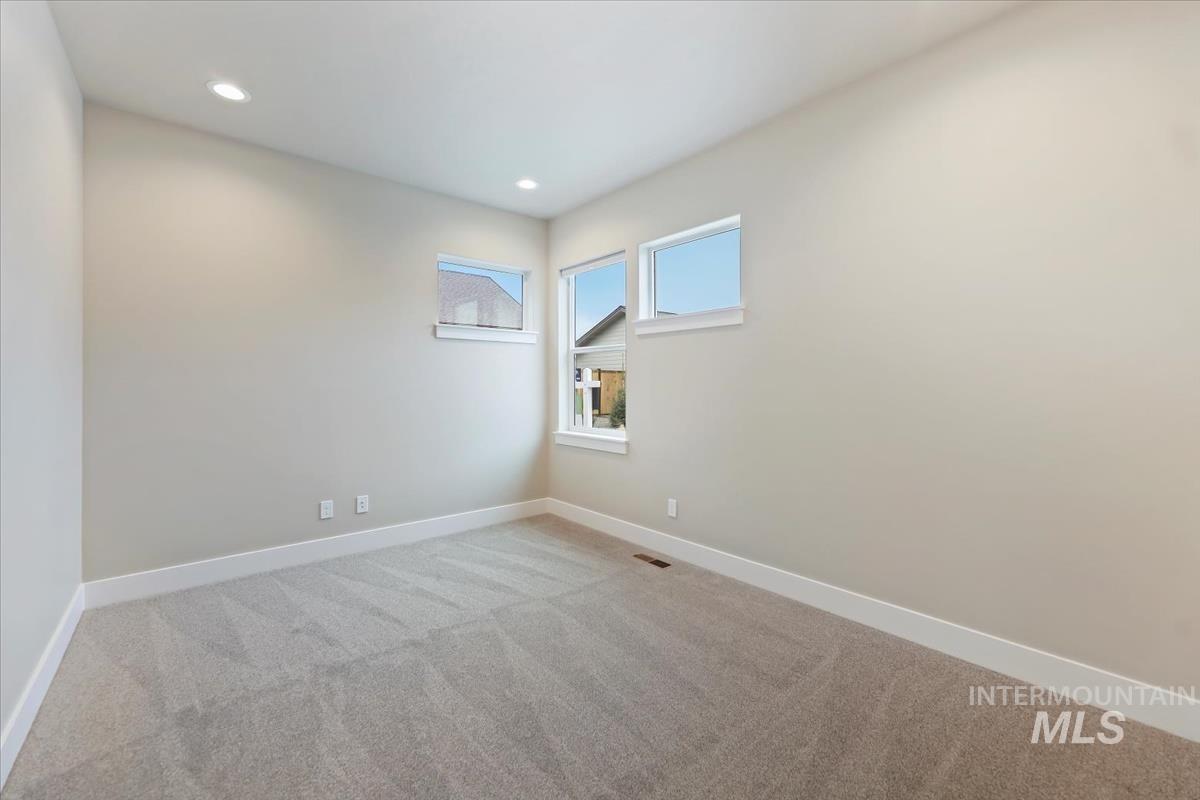 Unfurnished room featuring light colored carpet and recessed lighting