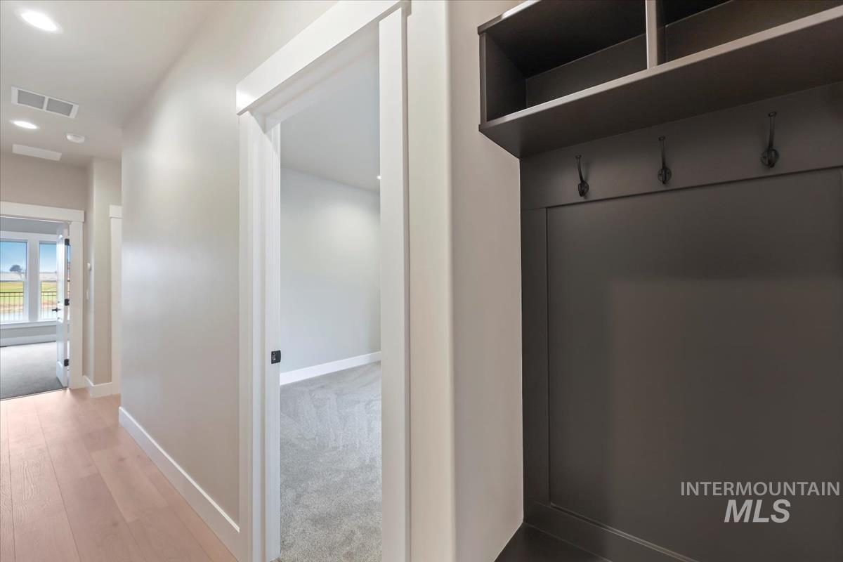 Mudroom with recessed lighting and wood finished floors